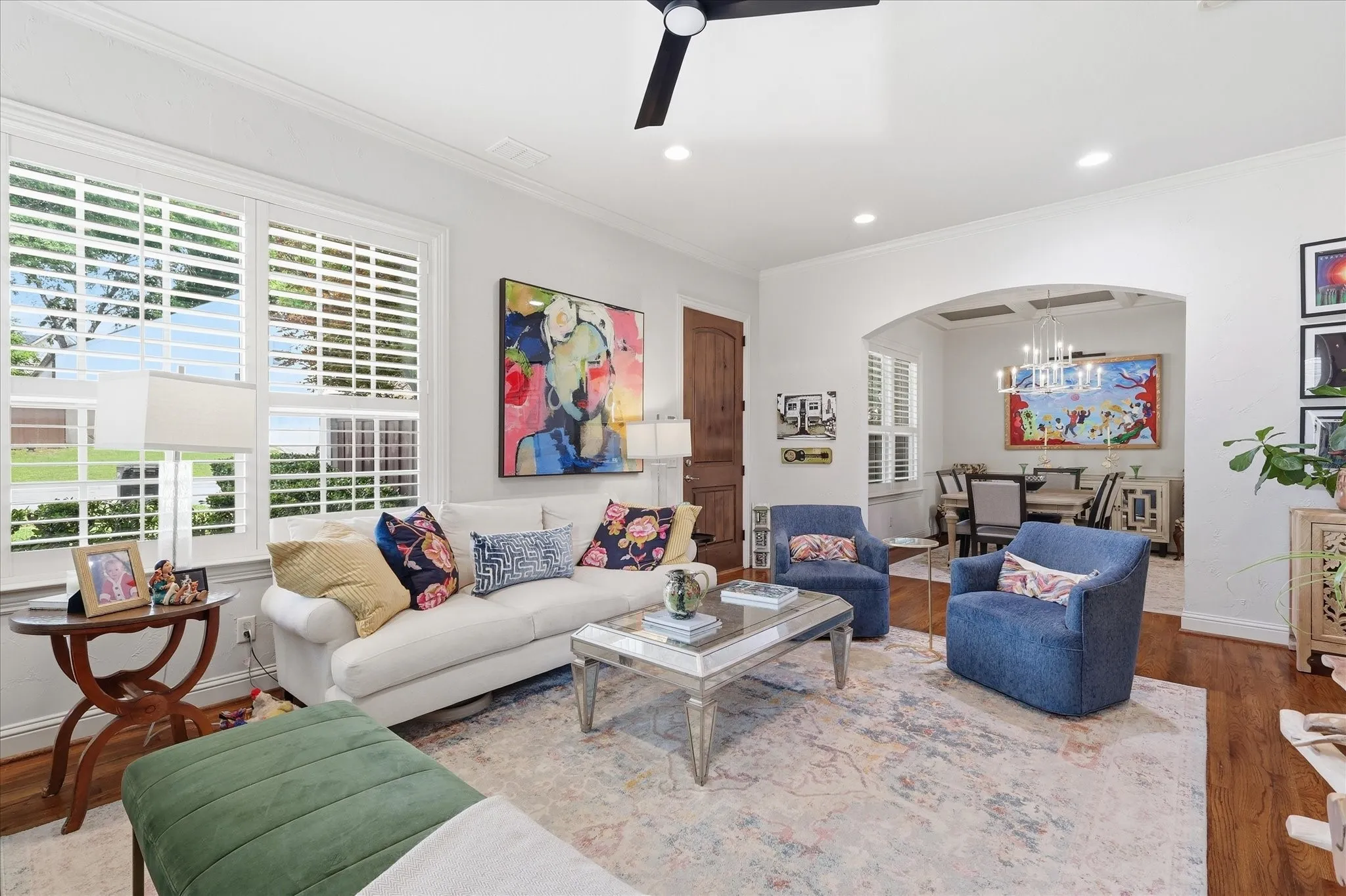The spacious living room with hardwood floors and plantation shutters sets the tone for this stunning townhome