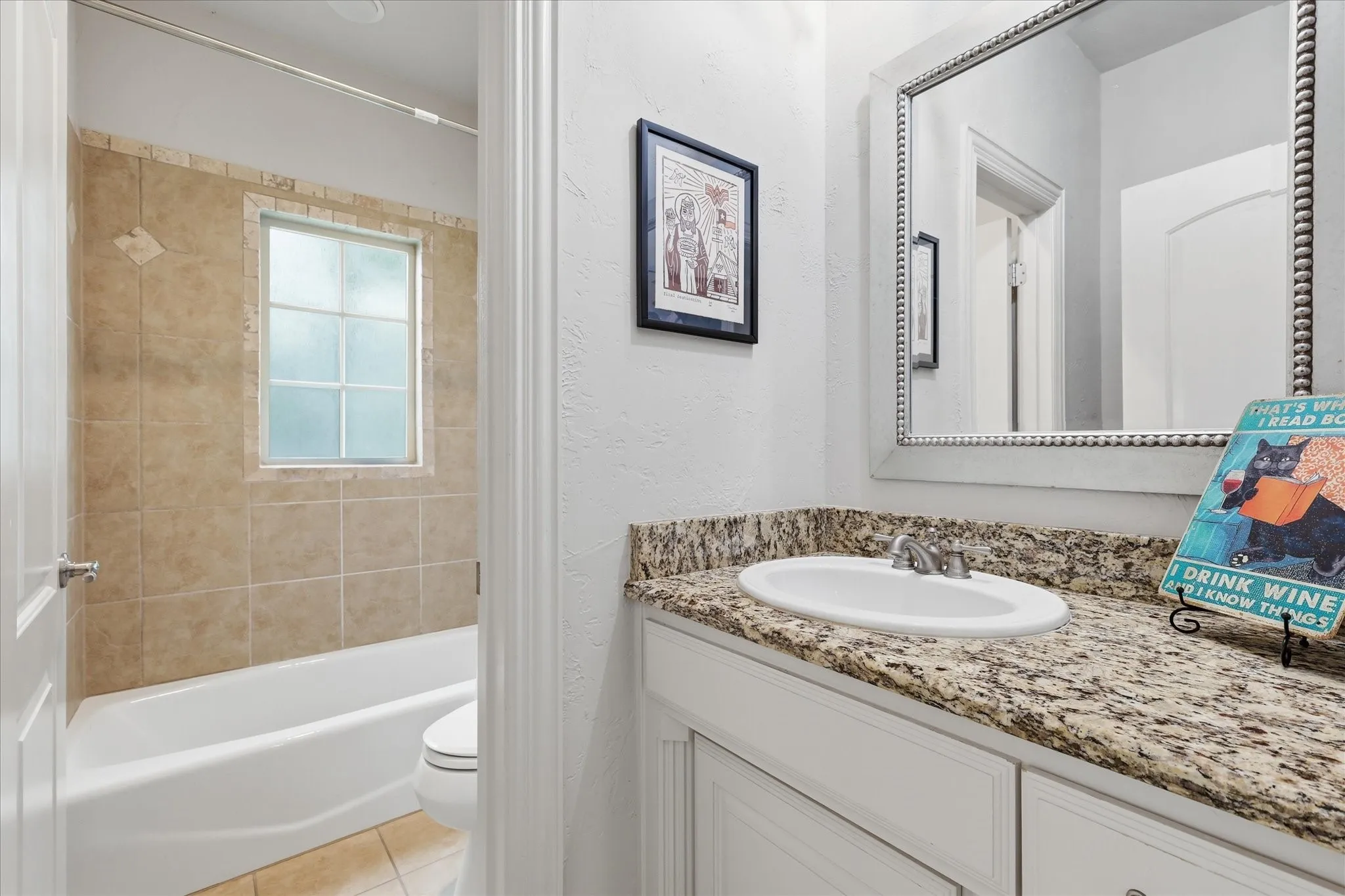 The second full bath upstairs is positioned by the secondary bedrooms