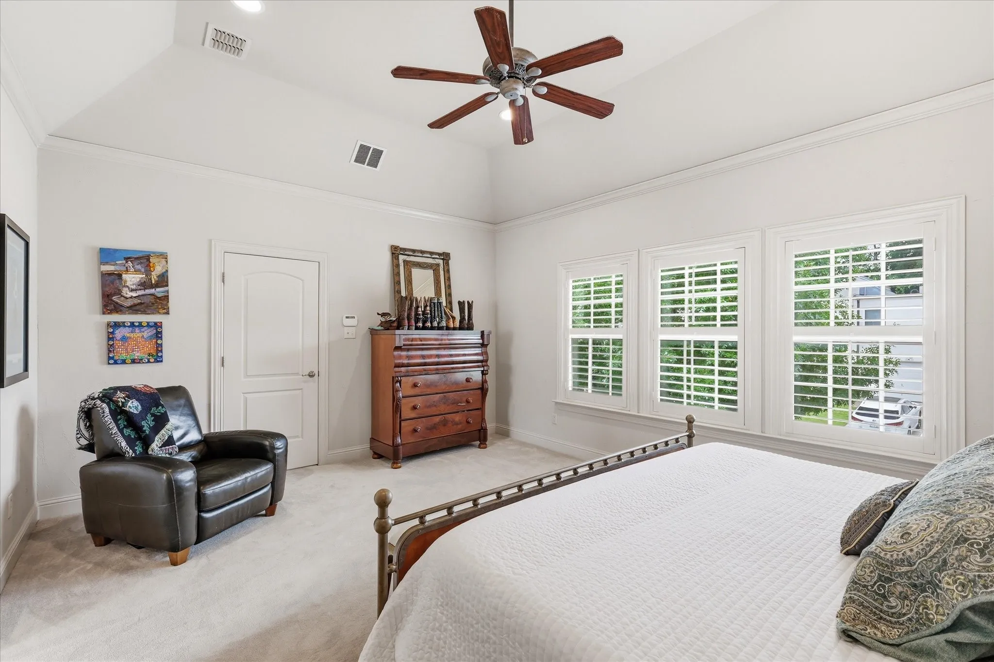 The primary bedroom has plantation shutters and plenty of space