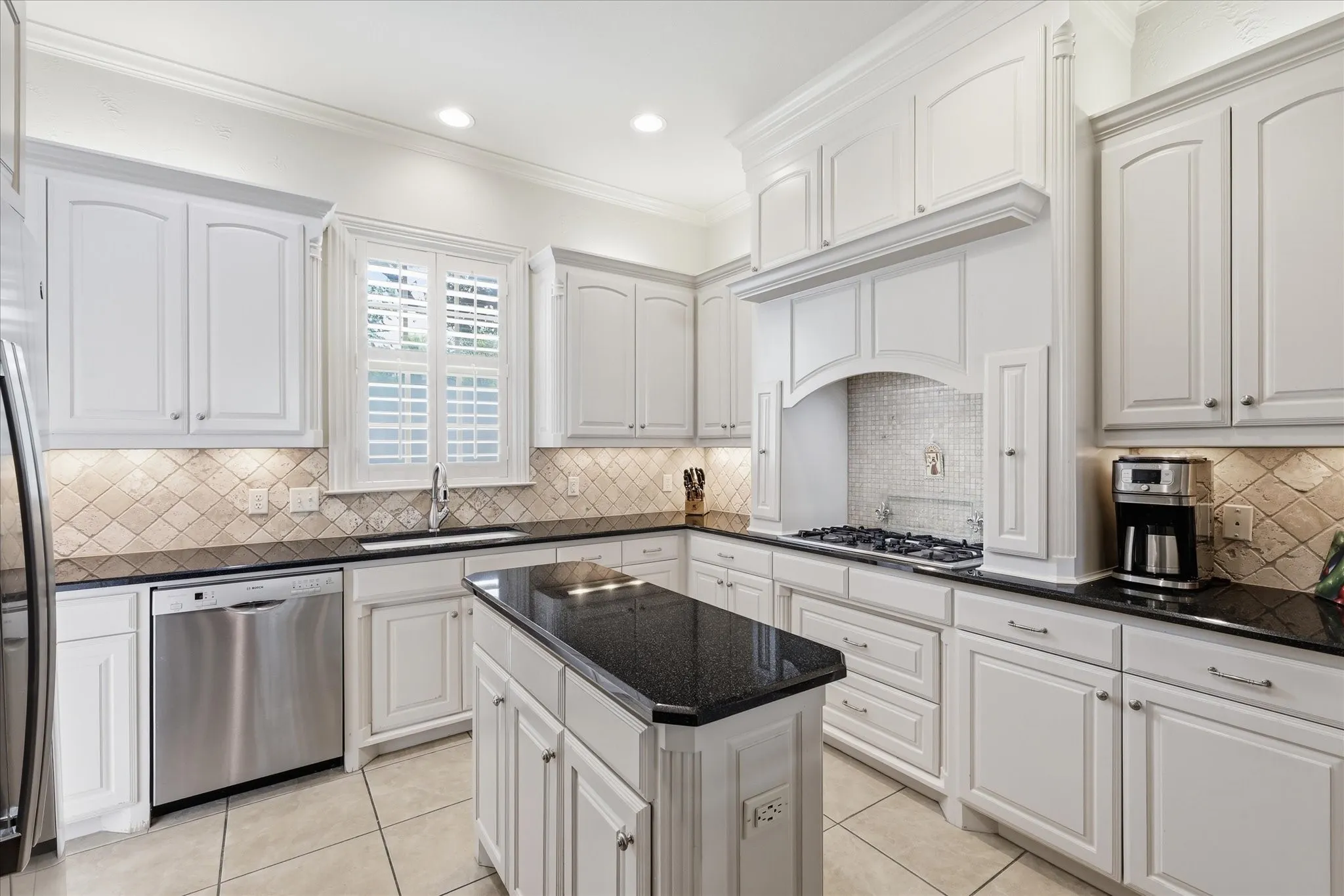 A gas cooktop, lots of cabinets for storage and plenty of countertop prep space create the perfect kitchen