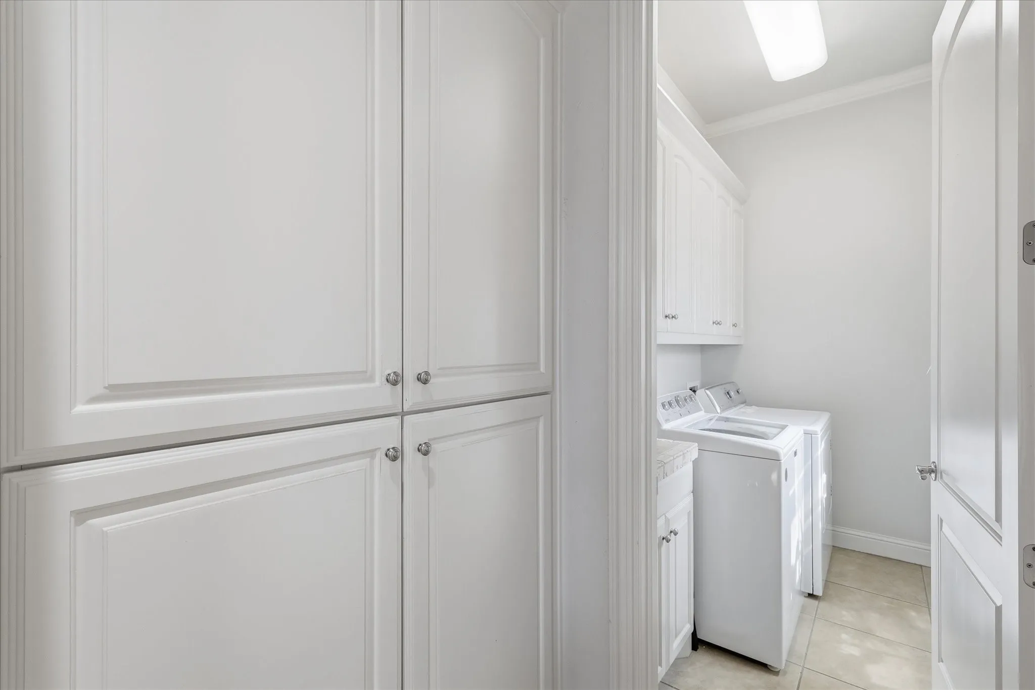 The mud room is just inside the garage and is equipped with space for pantry supplies and pet supplies