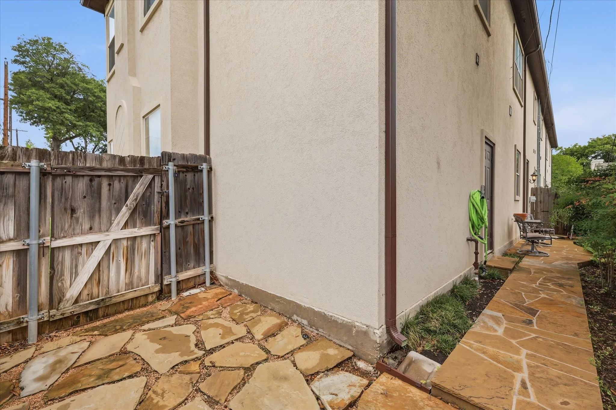 Another view of the side yard with an exterior storage room