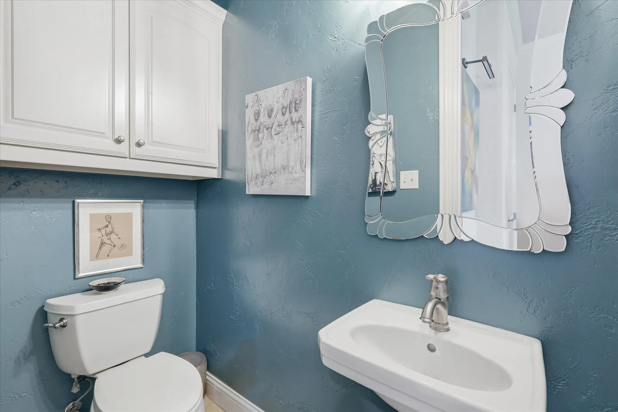 The half-bathroom on the first level is tucked away for guest use
