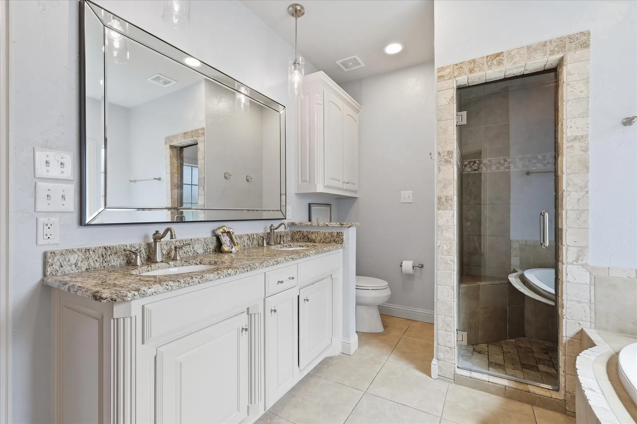 The primary bath is ensuite and offers a separate shower and tub