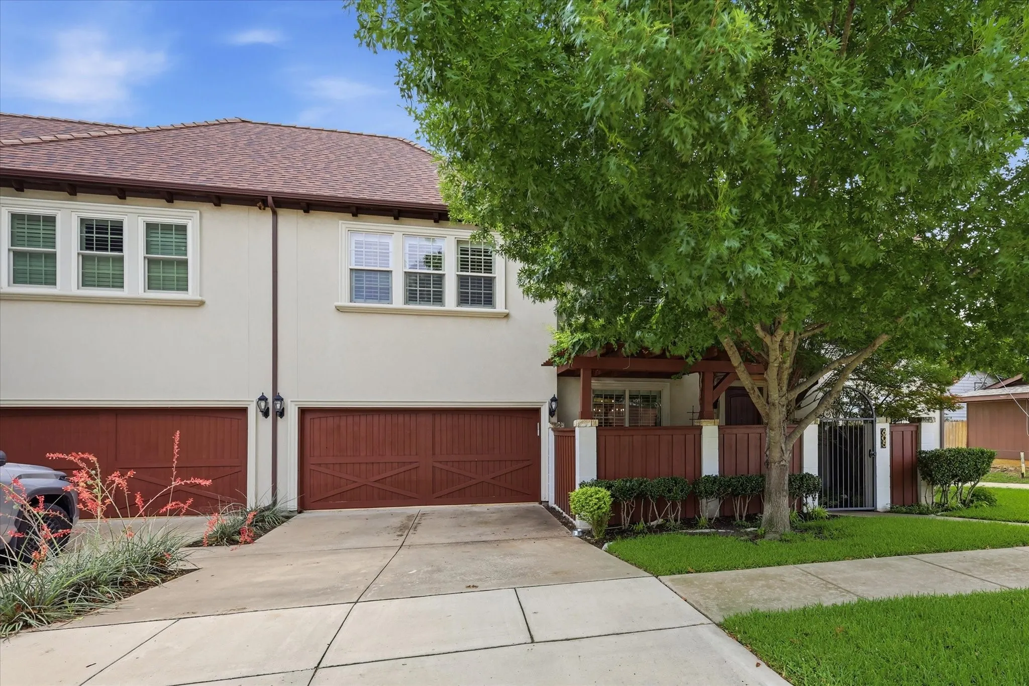 A view of the 2-car garage and well groomed front yard