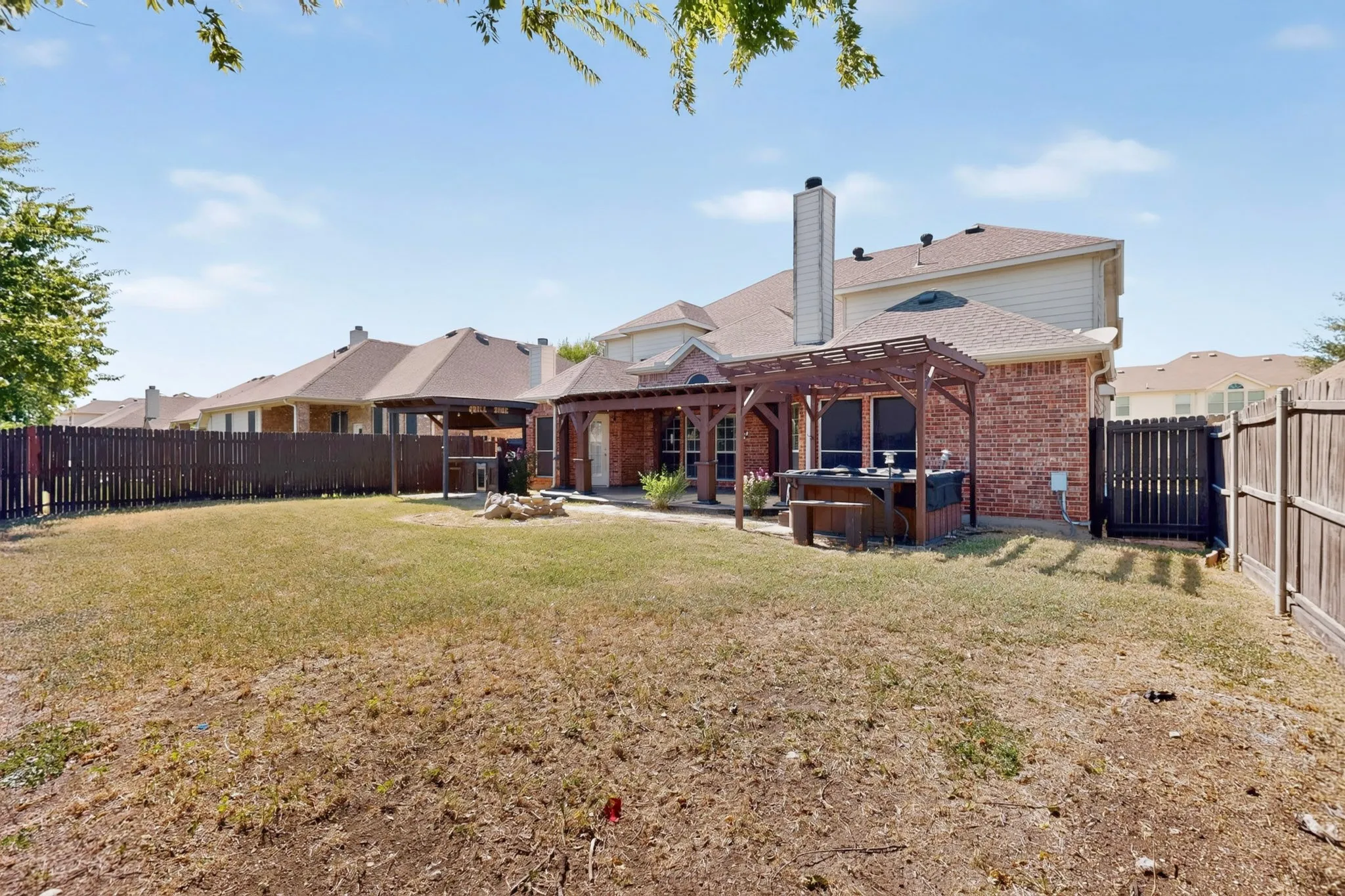 Brick exterior with a pergola and attached covered patio