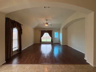 Arched Framed Entry into the Living Room with Entertainment Inset