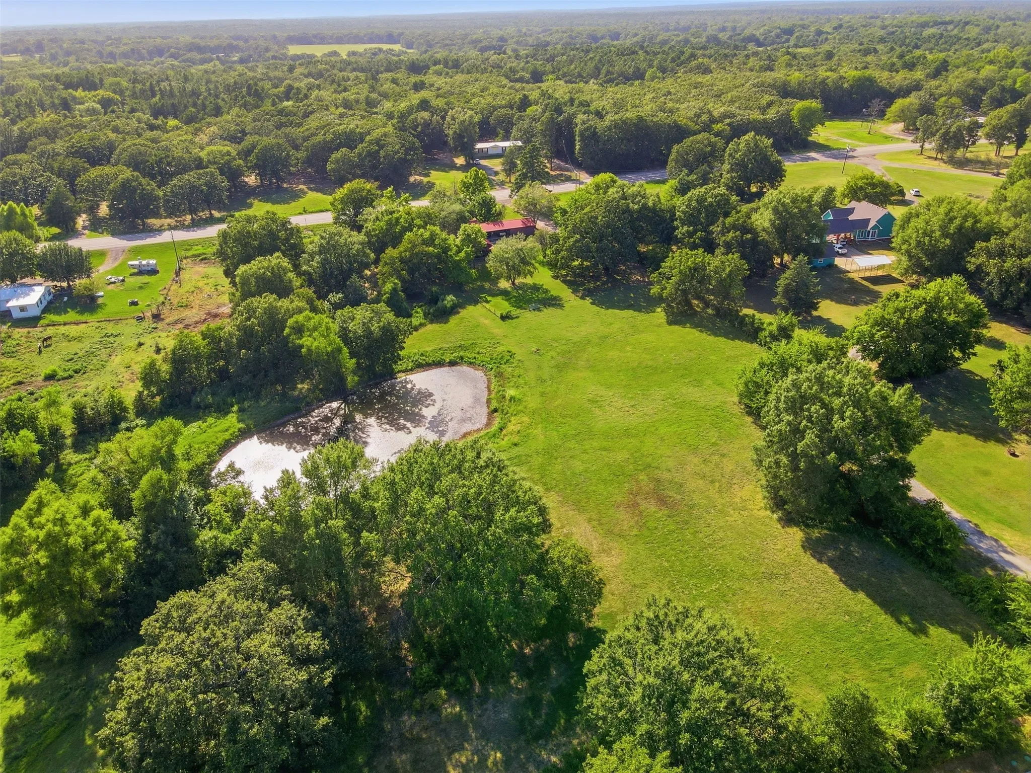 Expansive aerial perspective highlighting the surrounding countryside and expansive green acreage.