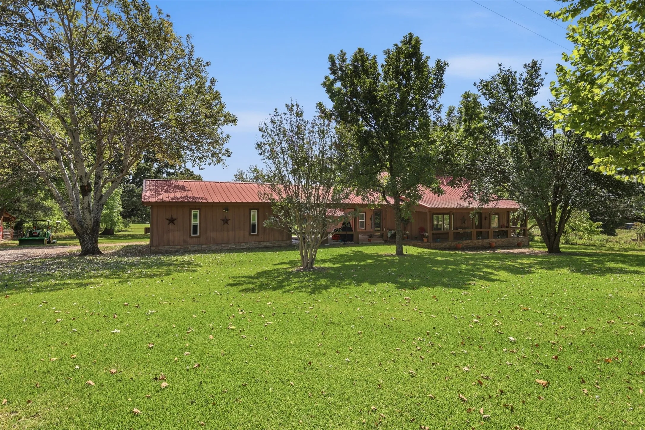 Alternate exterior perspective highlighting the spacious open property grounds.