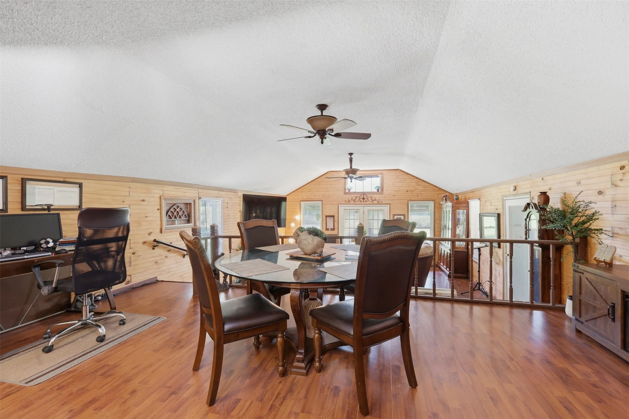 Open dining area with vaulted ceilings, chandelier lighting, and room for a large dining table.