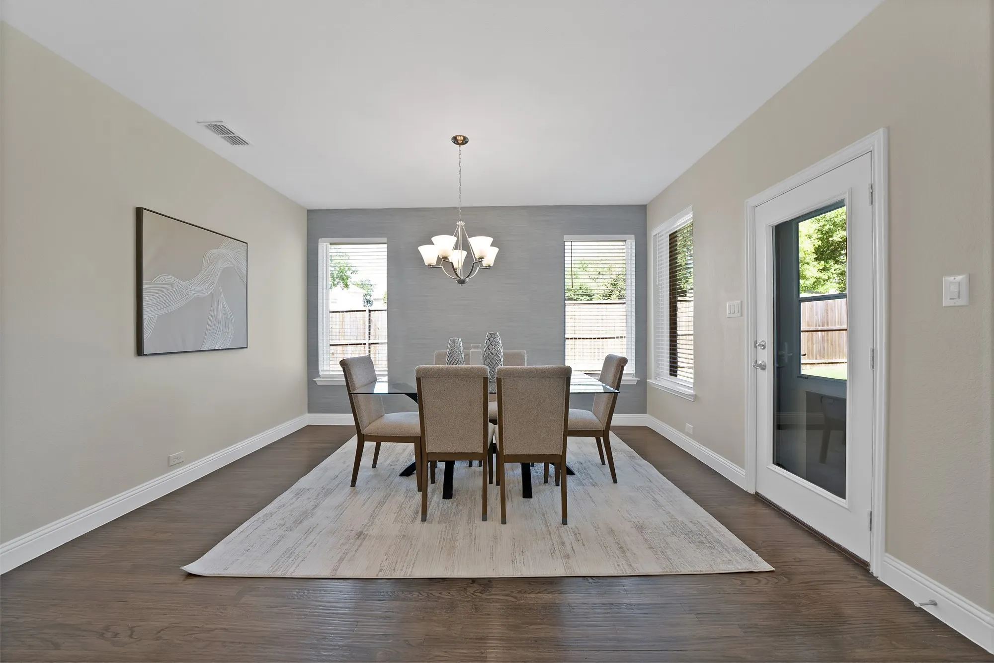 Wood-finish flooring, white baseboards, and a glass-paneled exterior door