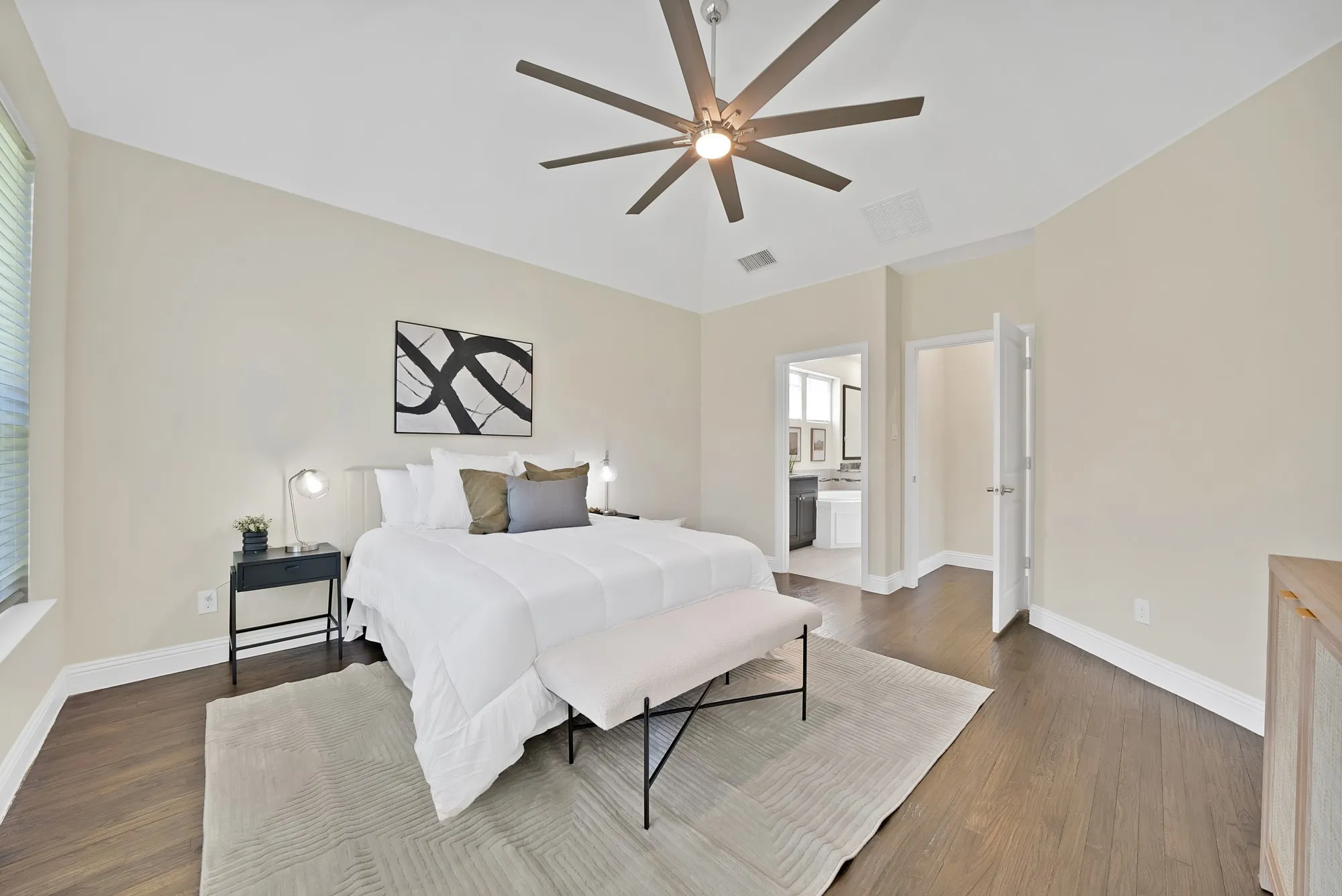 Vaulted ceilings featuring a ceiling fan, dark wood-finish flooring, and light-toned walls