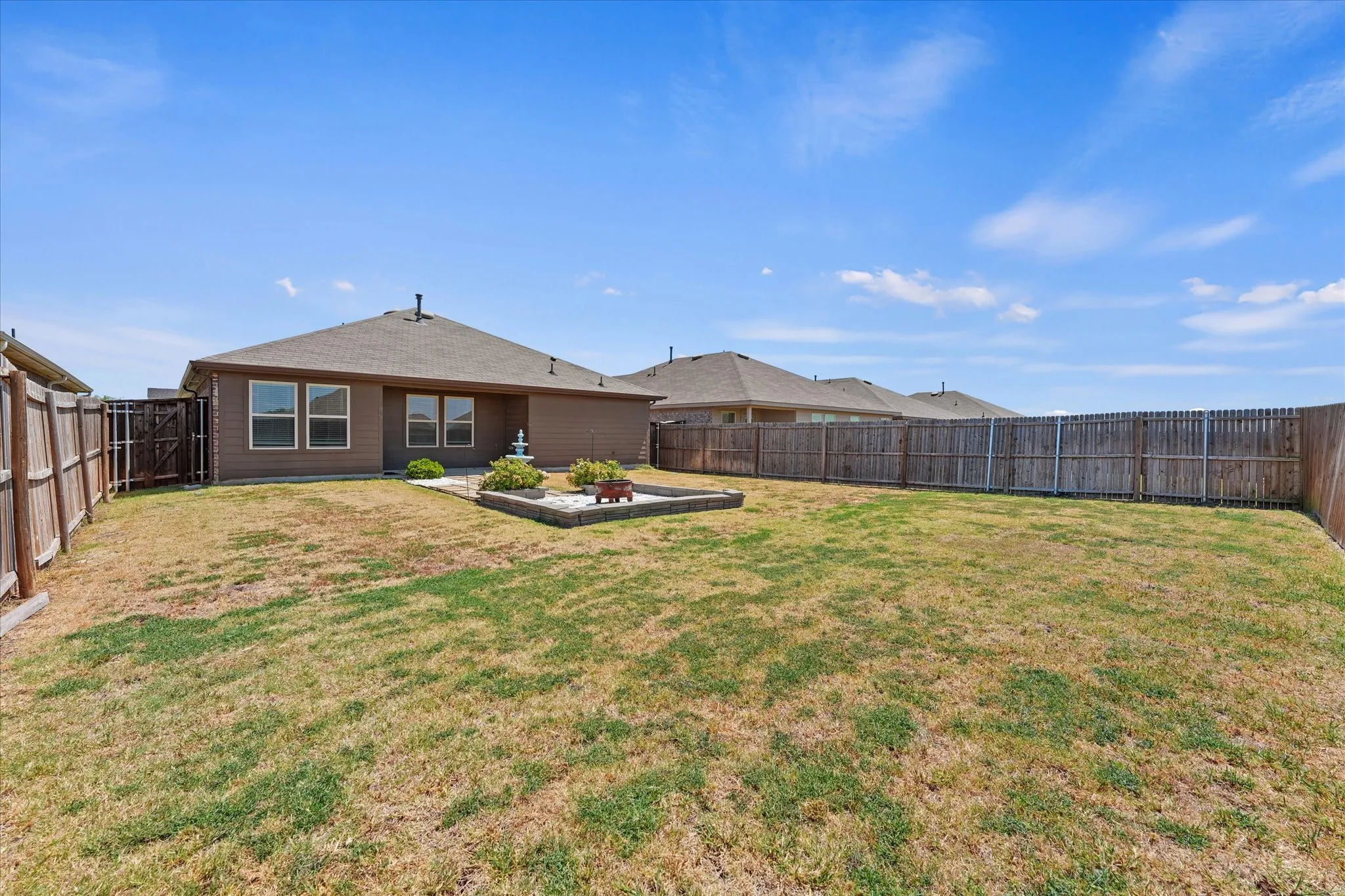Expansive backyard featuring a wood fence