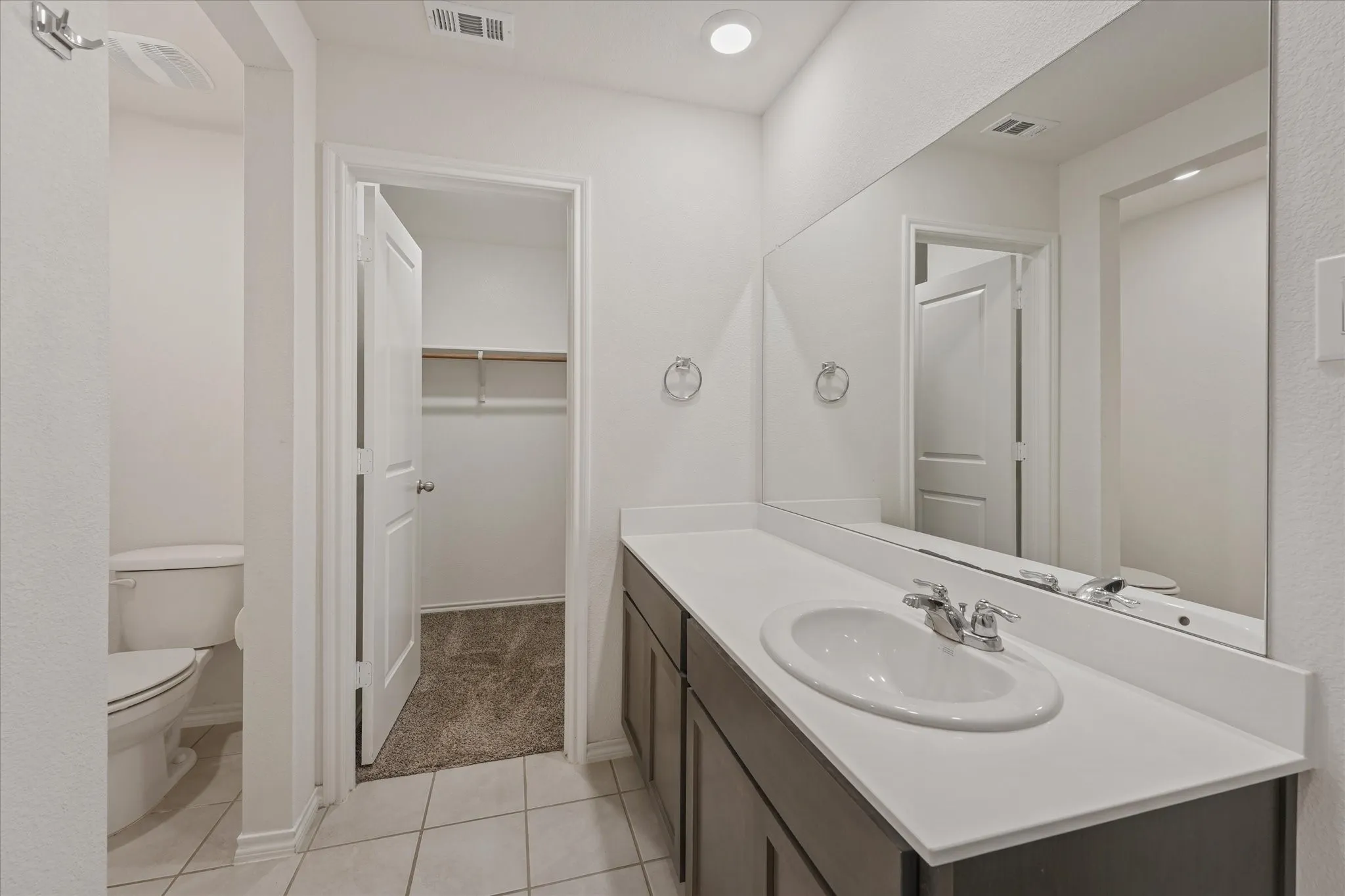 The large vanity has plenty of room. Notice the walk in closet.