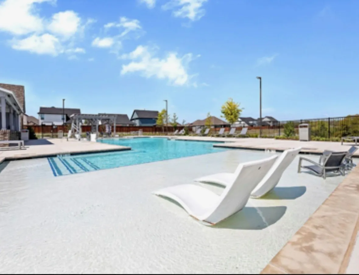 Community pool with a patio