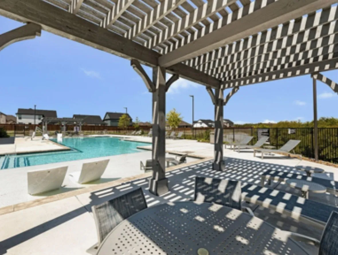 View of patio with a community pool and a pergola