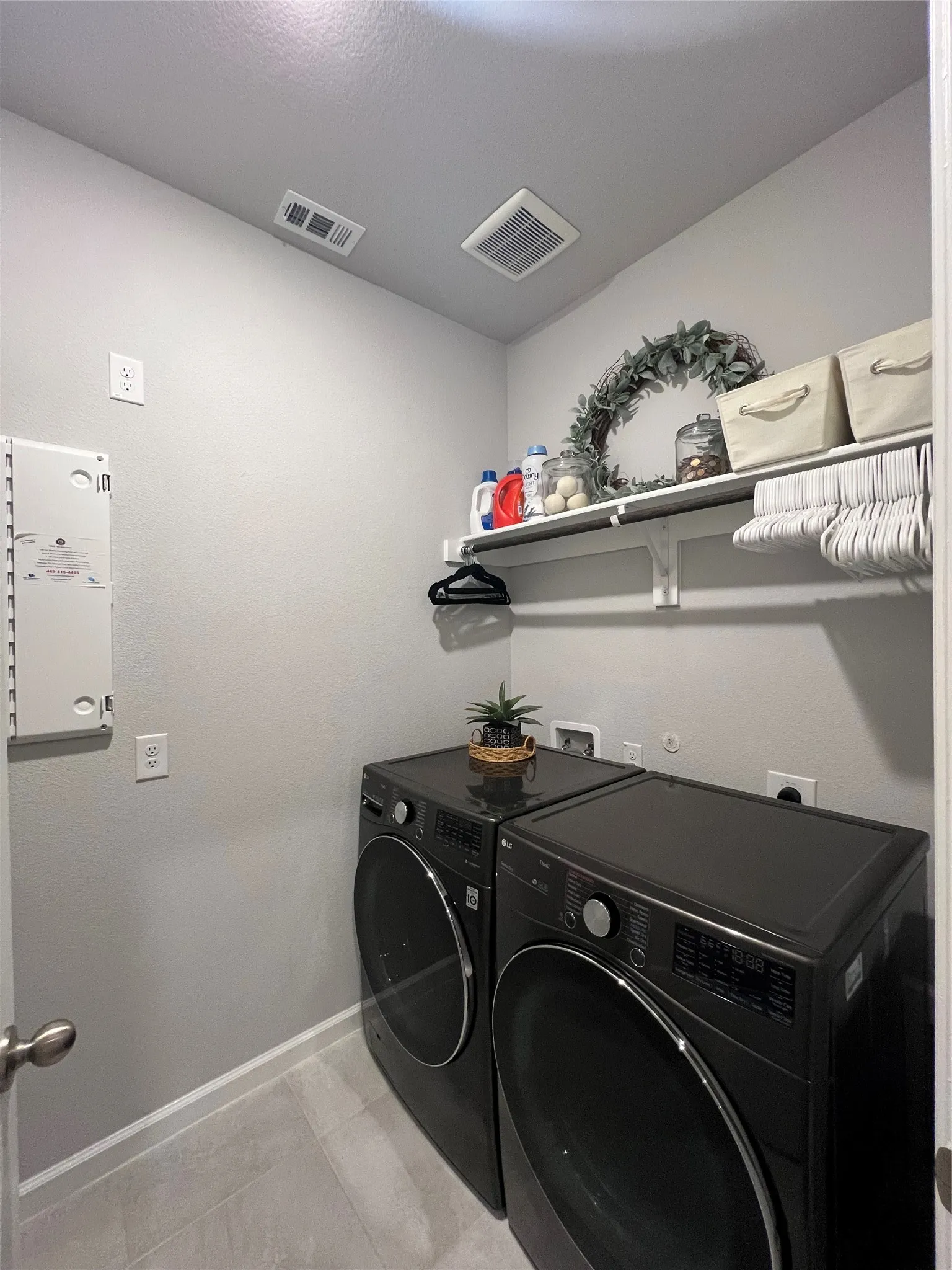 Laundry room featuring baseboards and separate washer and dryer