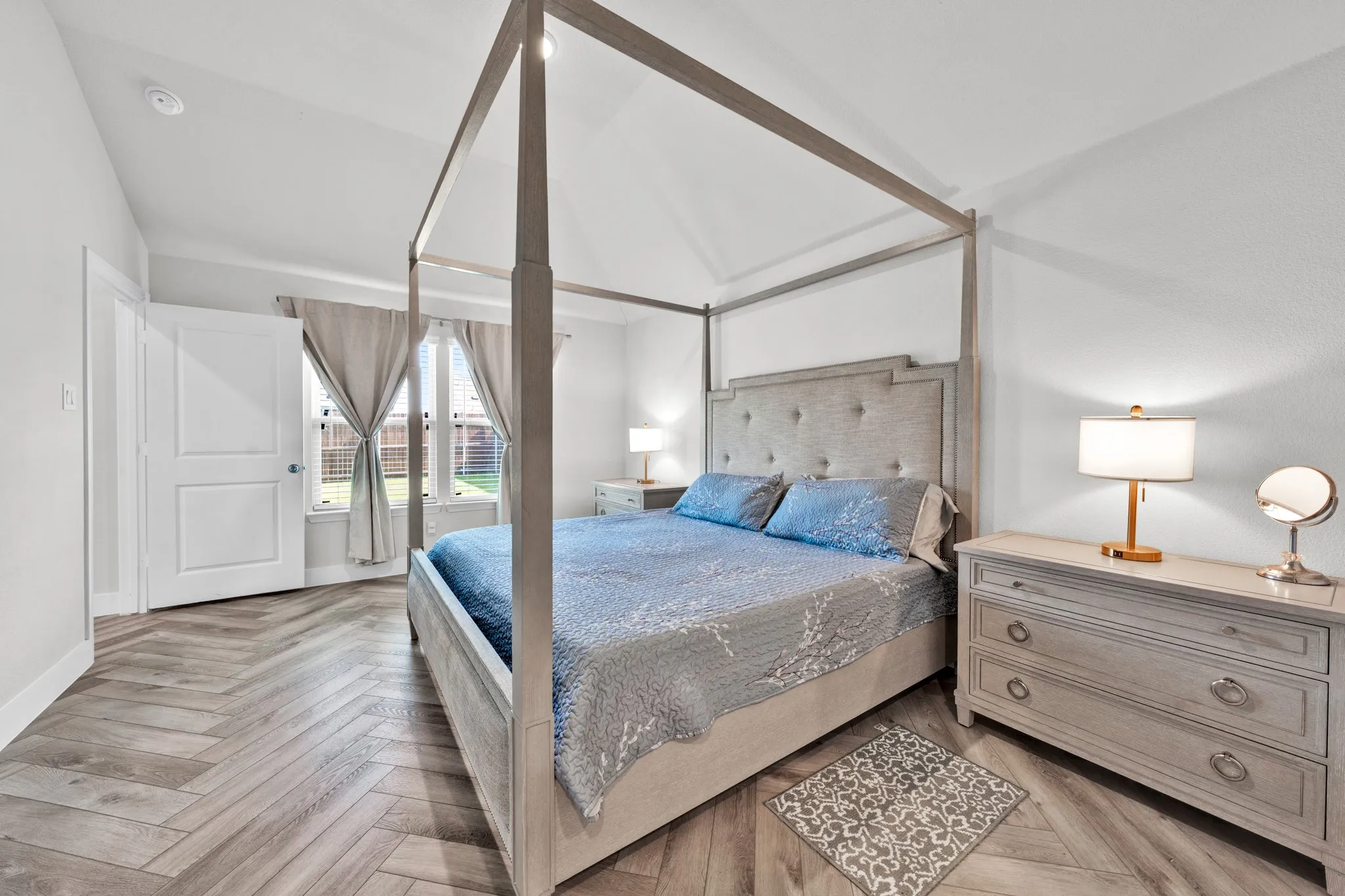 Vaulted ceiling featuring a ceiling fan, recessed lighting, and herringbone-pattern wood-finish flooring