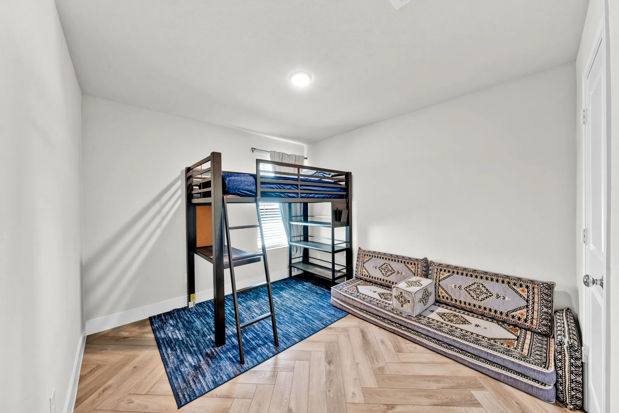 Herringbone wood-finish flooring with crisp white walls