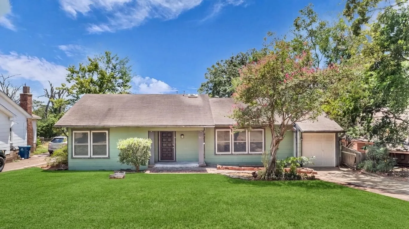 Light green exterior with a gabled roof and attached garage
