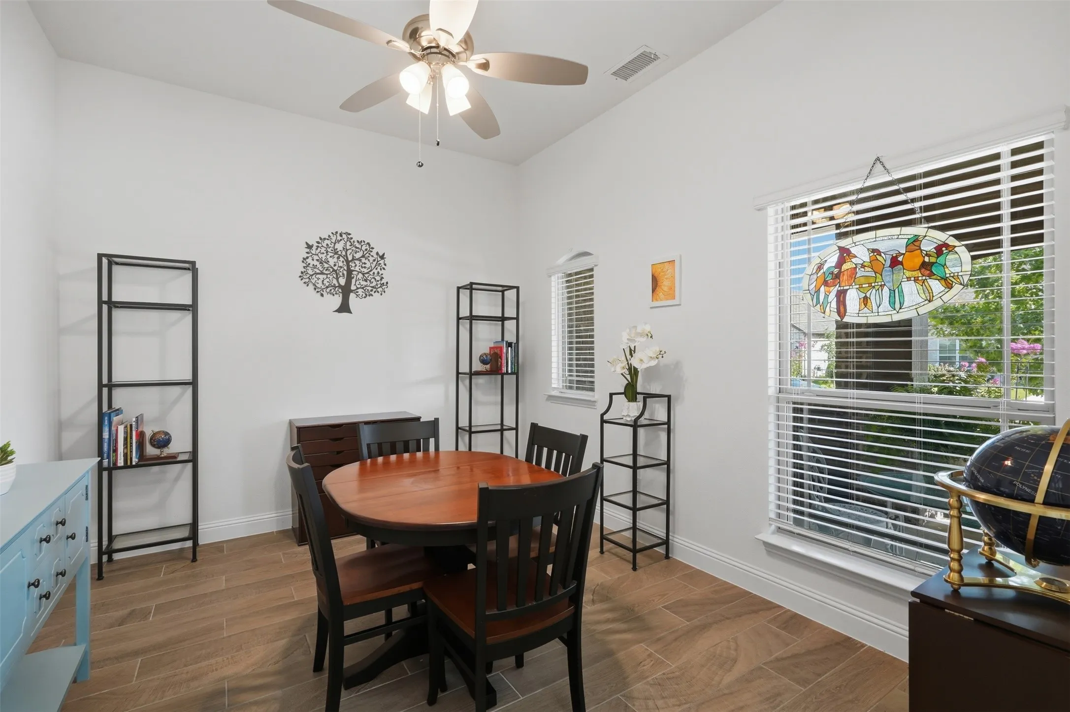 Vaulted ceilings and warm wood-finish flooring enhance the room’s open, inviting feel, creating a comfortable space to relax and unwind