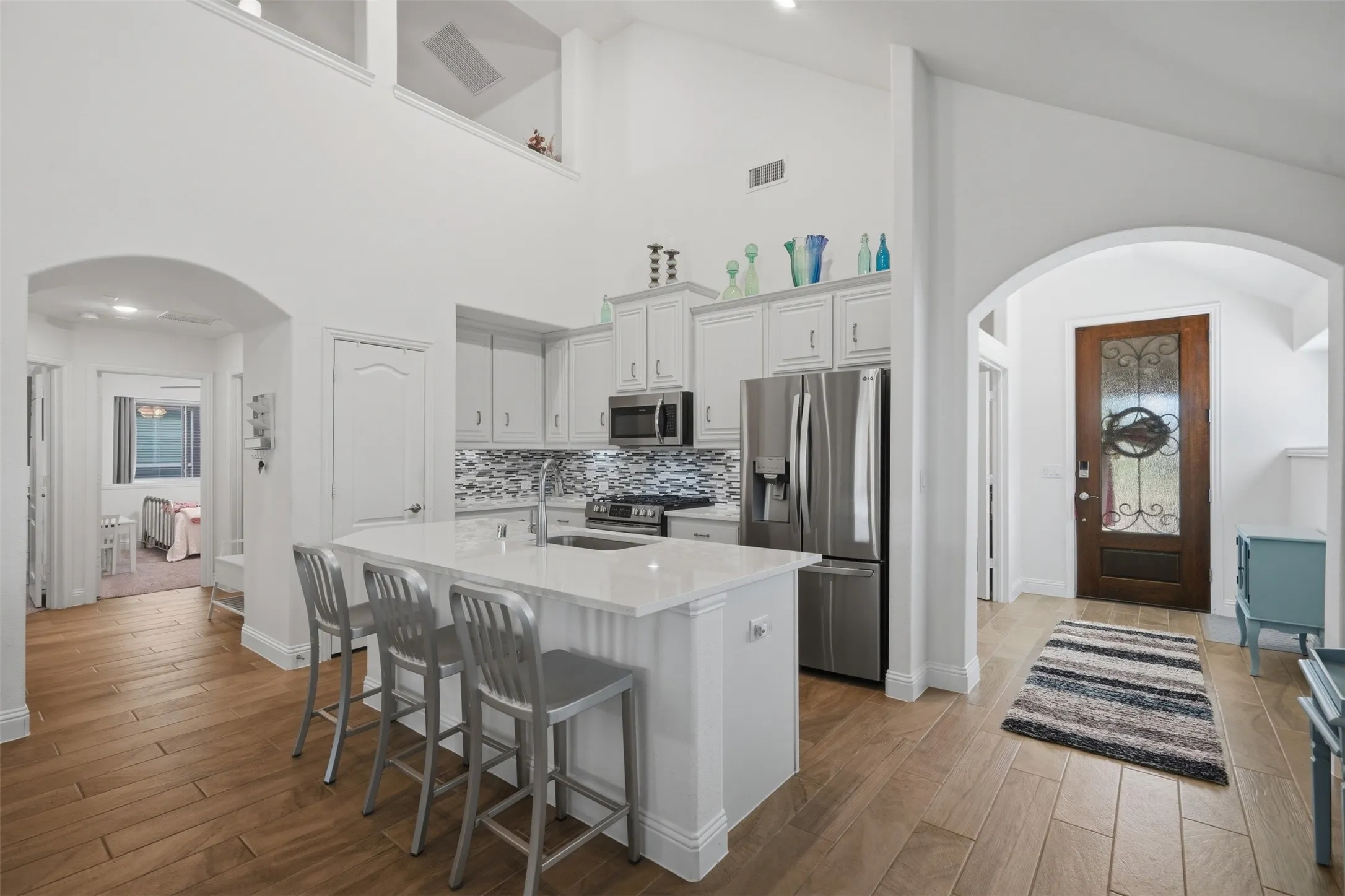 Bright, open space enhanced by architectural archways and soaring vaulted ceilings, creating an airy and inviting atmosphere