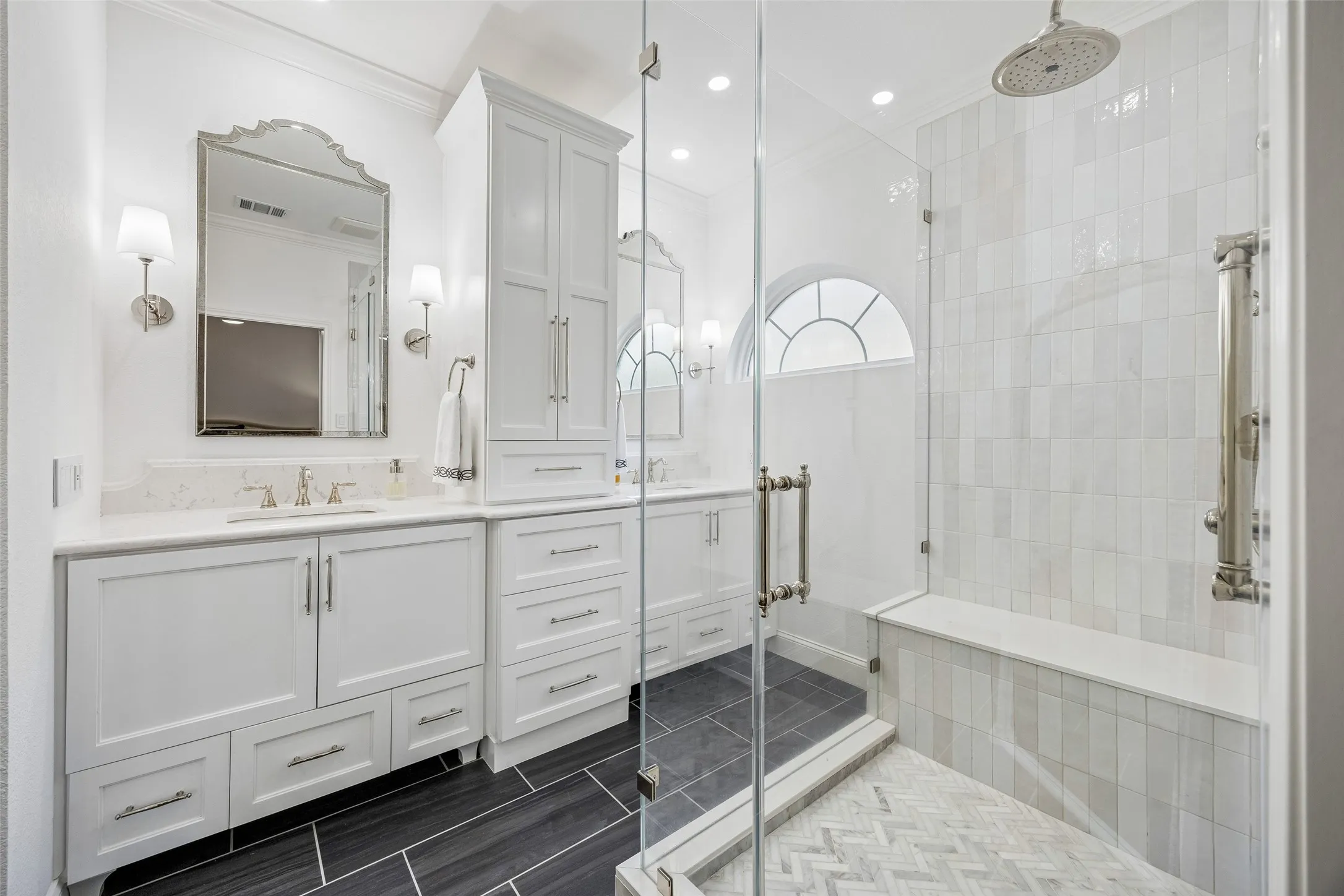 A Fully Renovated Primary Bath - Custom cabinetry, quartz-style countertops, polished nickel fixtures, recessed lighting, and large-format floor tile give this updated bath a bright, tailored feel.
