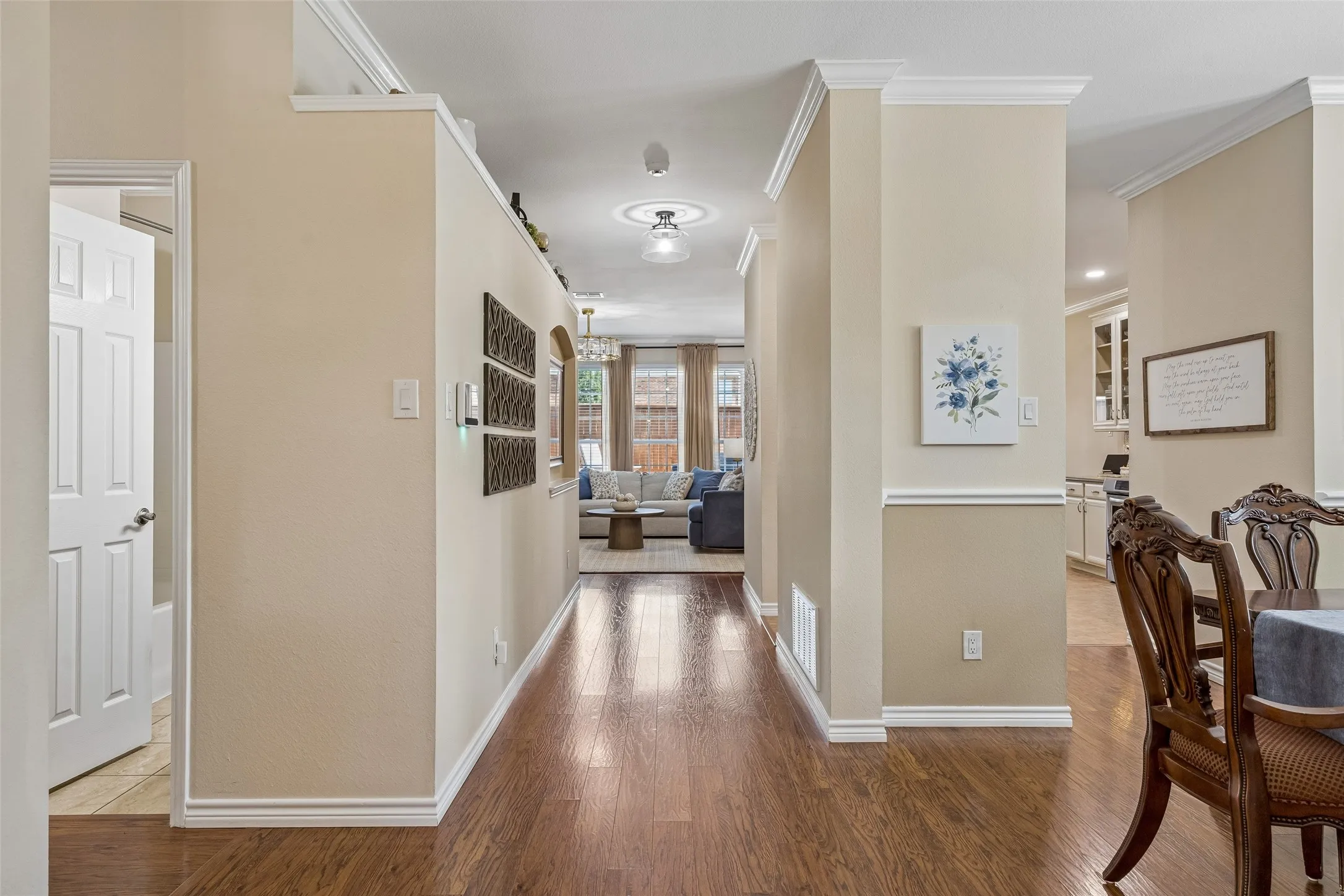 A Layout That Draws You In - The extended entry provides a clear sightline toward the main living areas, while architectural columns, crown molding, and defined room transitions give the home character without interrupting the flow.