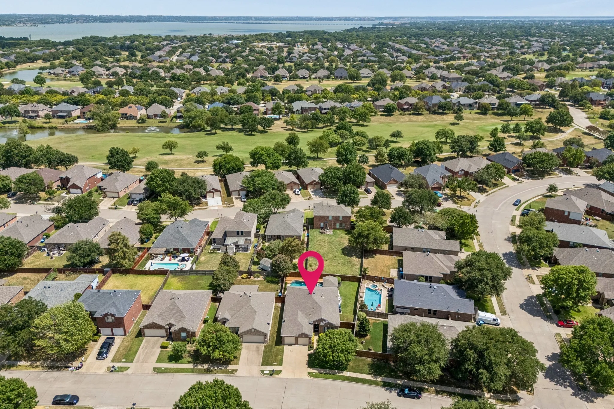 Close to the Course Without Being On It - This aerial perspective shows the subject property just one street off the golf course, offering convenient access to Waterview’s surroundings while maintaining a residential setting away from direct course frontage.
