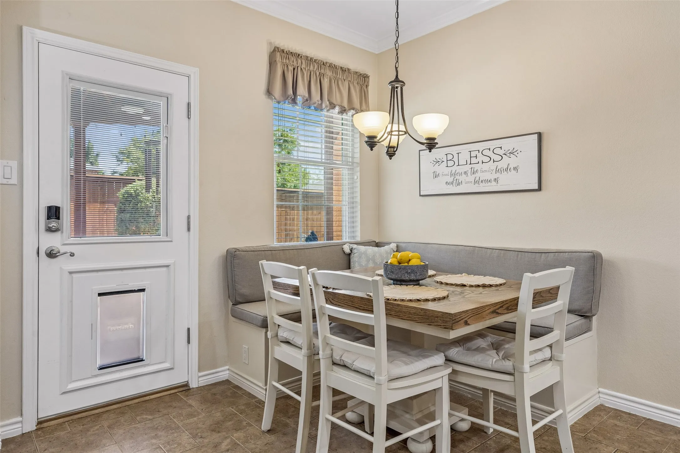 A Breakfast Nook with Built-In Function - The breakfast area features a custom corner bench with built-in storage, giving the space added functionality while keeping casual meals close to the kitchen and backyard access.