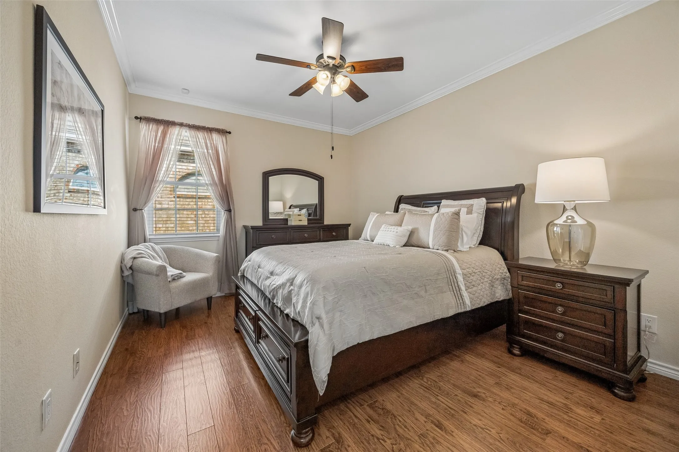 Bedroom Three with Flexible Space - Updated flooring, crown molding, a ceiling fan, and a well-proportioned layout give this secondary bedroom the flexibility to serve as a bedroom, guest space, or additional work-from-home​​‌​​​​‌​​‌‌​‌‌​​​‌‌​‌​‌​‌​​​‌​​ area.