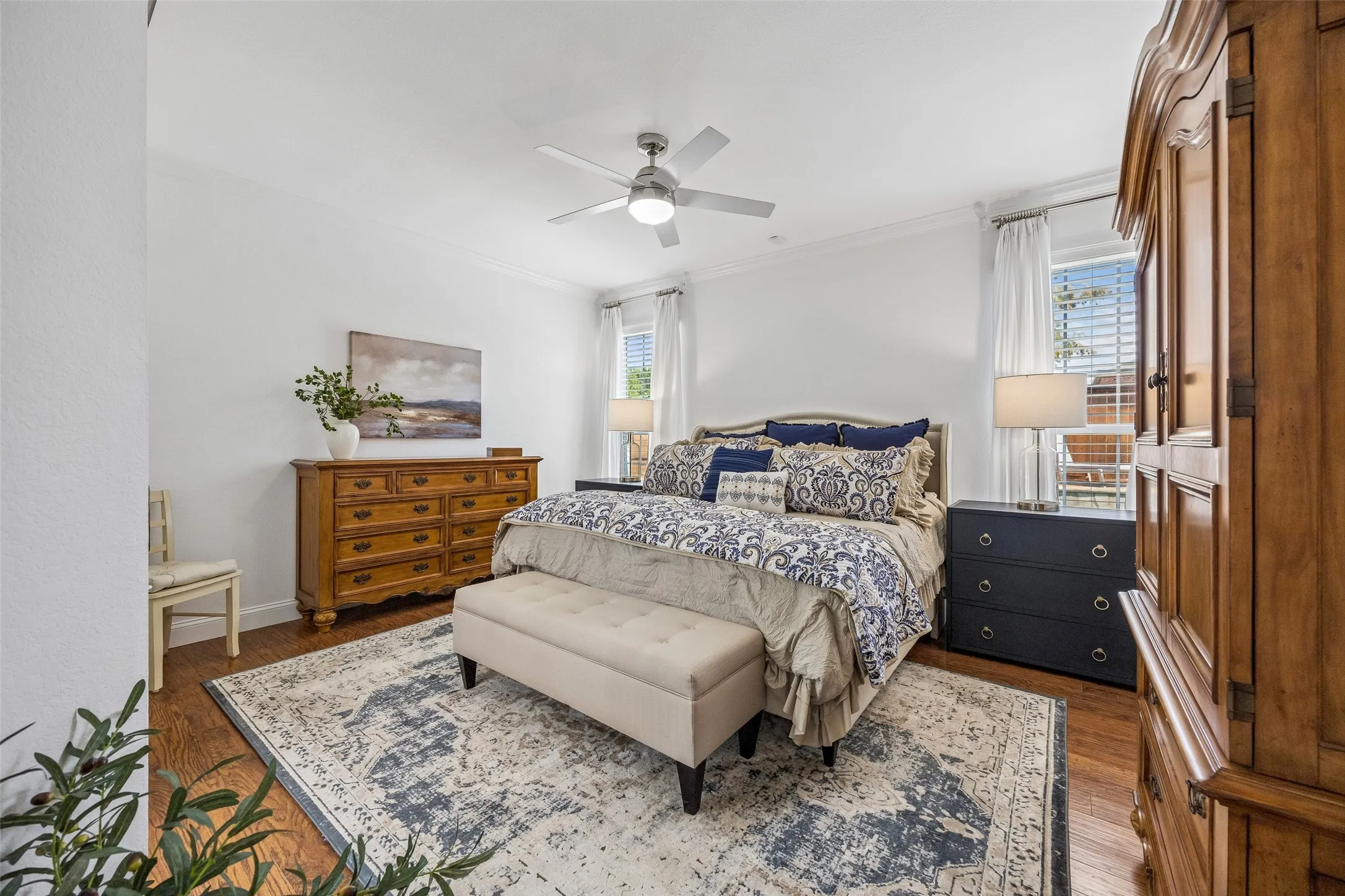 A Comfortable Primary Retreat - The primary bedroom offers generous proportions, updated flooring, crown molding, a ceiling fan, and natural light, creating a calm, comfortable space at the end of the day.