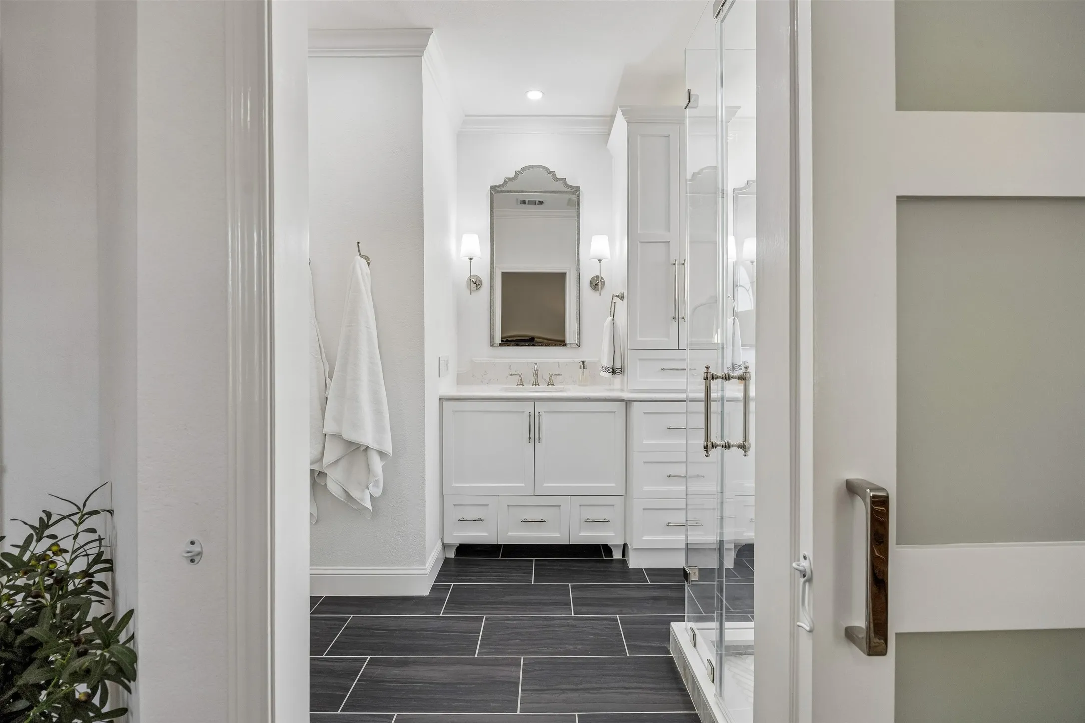 A Direct Connection to the Renovated Bath - The primary bedroom opens to the ensuite through a frosted-panel barn door, adding architectural interest while keeping the transition between spaces clean and functional.