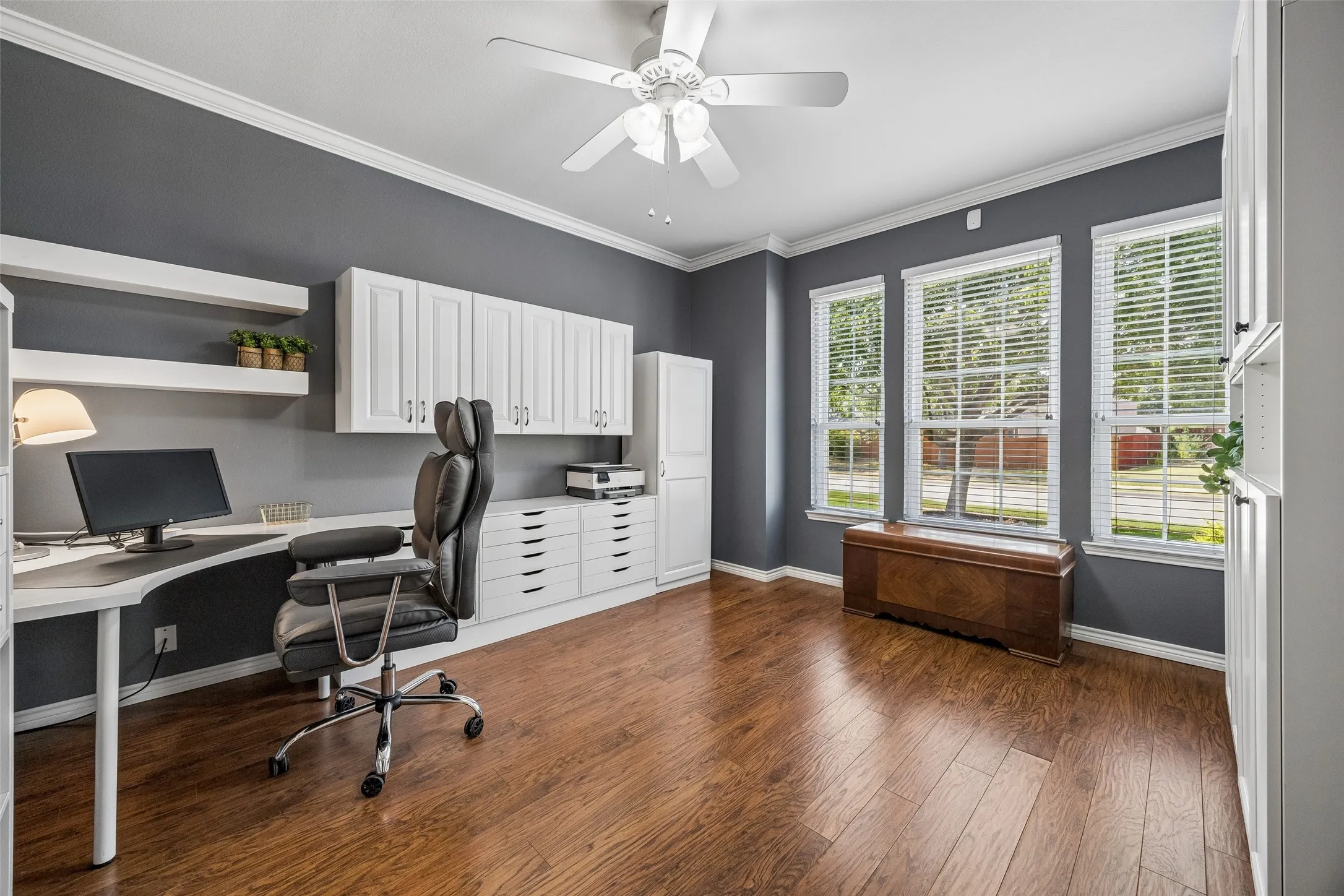 A Home Office Designed to Work - The front living area has been transformed into a spacious office with an extensive built-in workspace, cabinetry, shelving, crown molding, and plenty of room to stay organized. Ask us about what stays.
