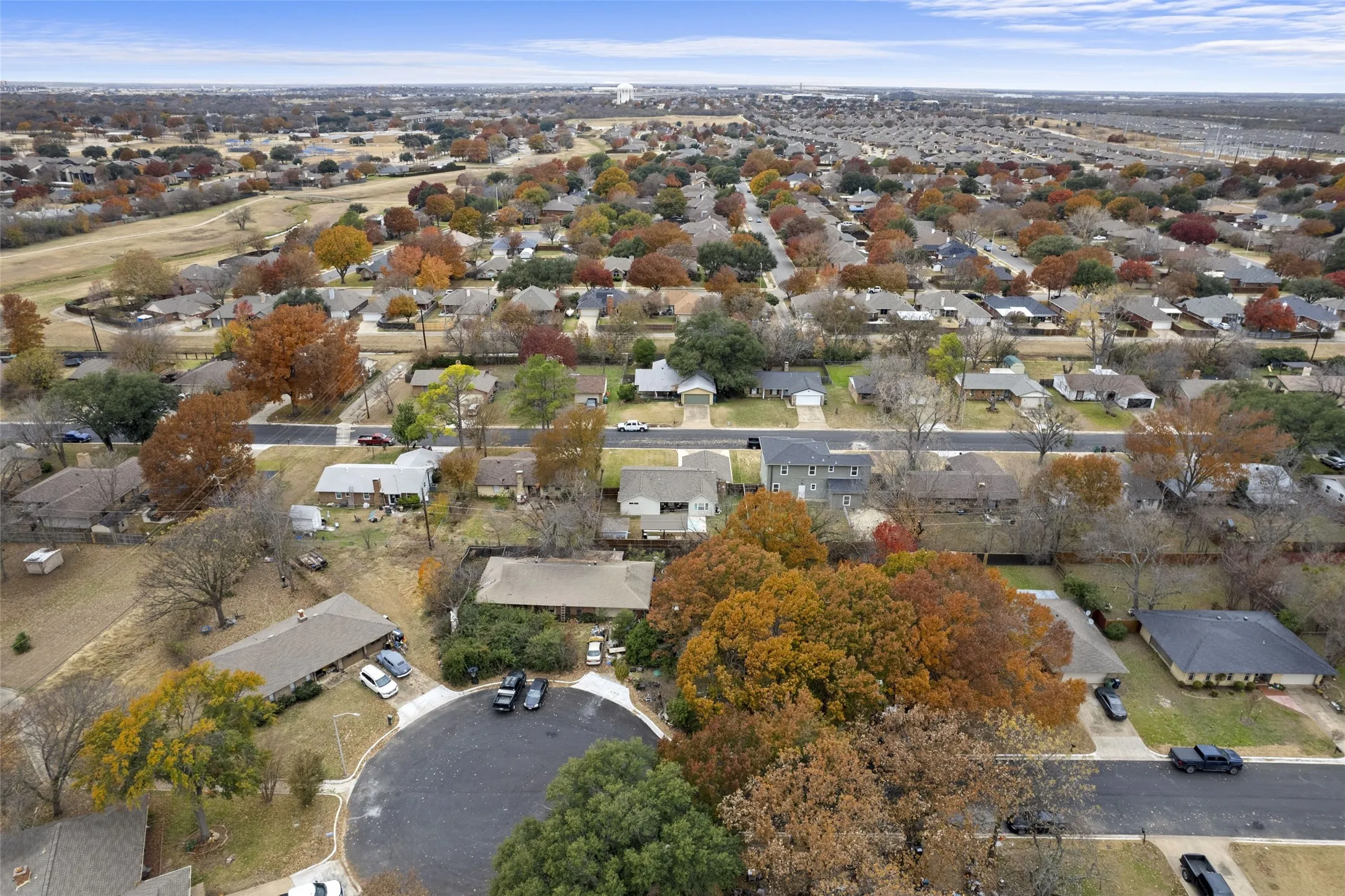 Residential neighborhood featuring mature trees and a clear sky