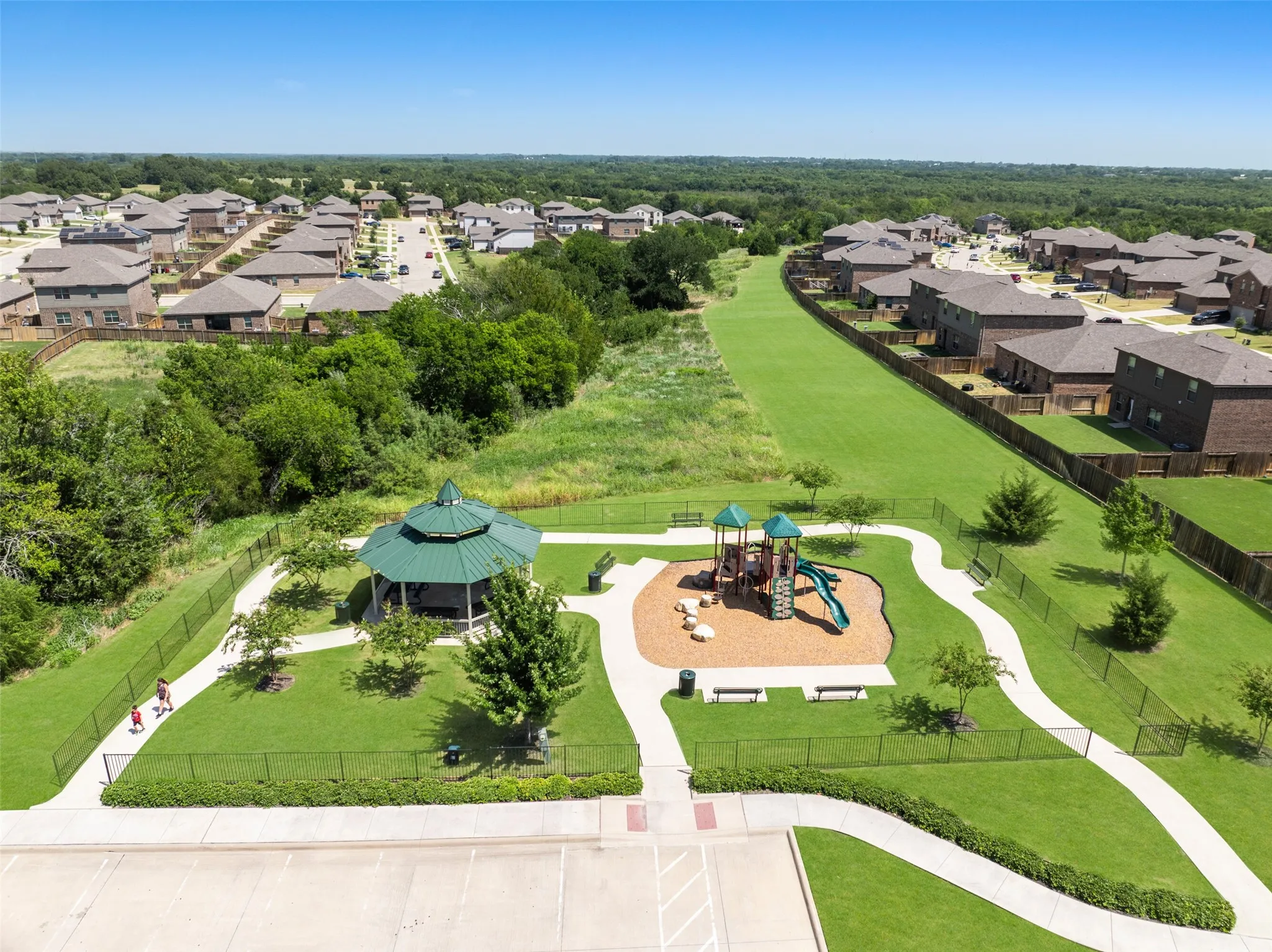 Community park featuring a playground, gazebo, and walking paths