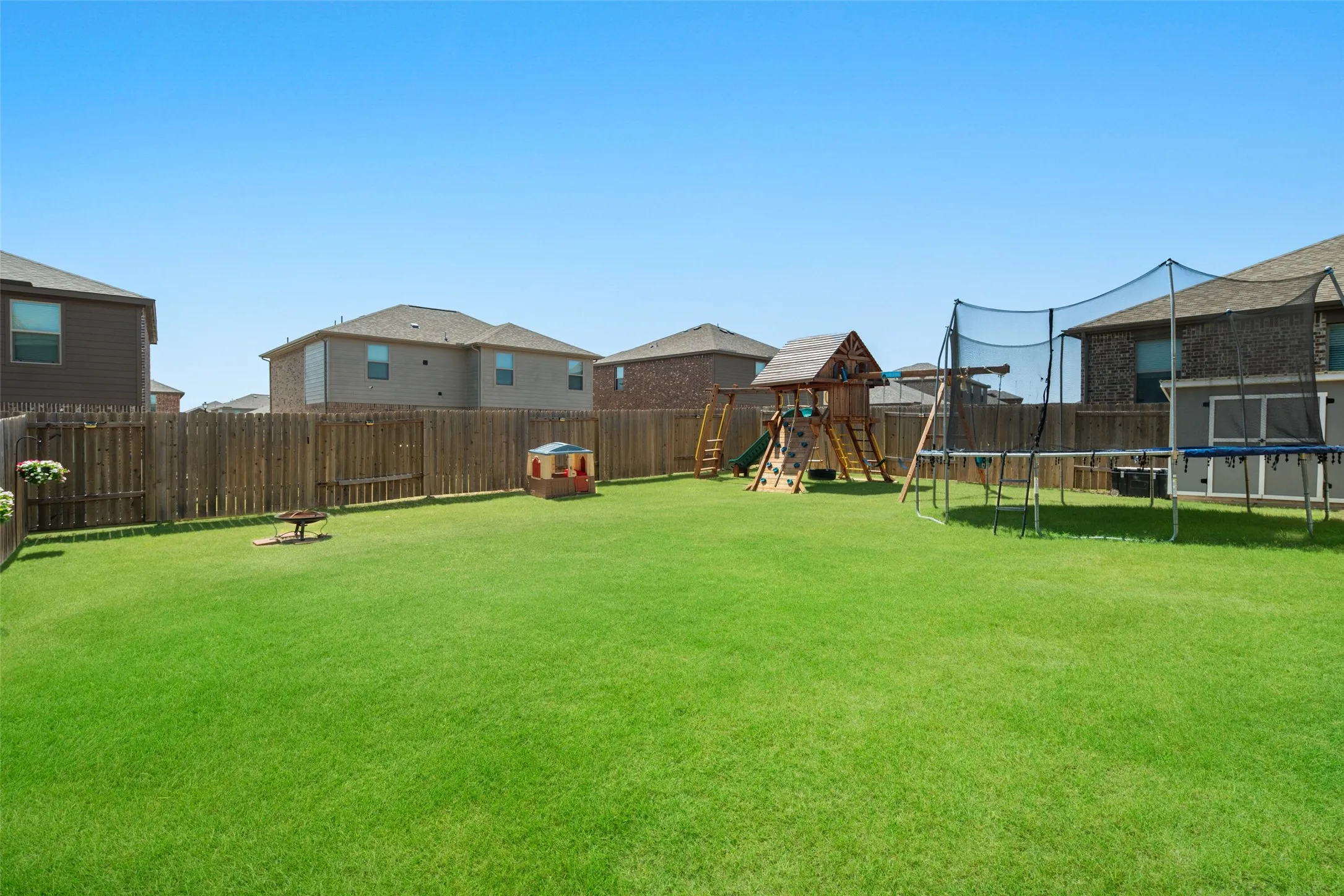 Expansive rear lawn with a full privacy fence