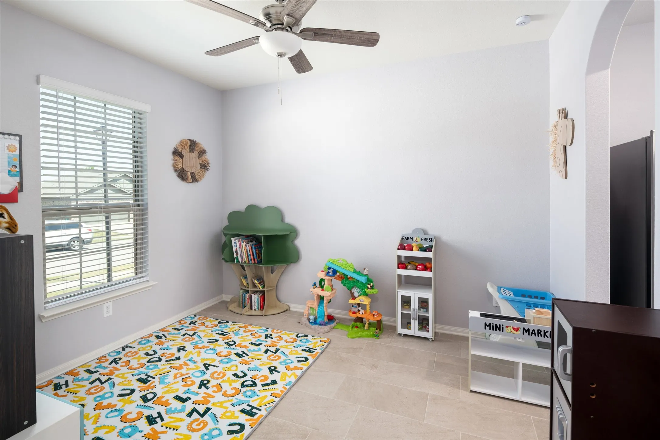 Recessed window with blinds, ceiling fan with integrated lighting, arched entryway, and neutral wall paint