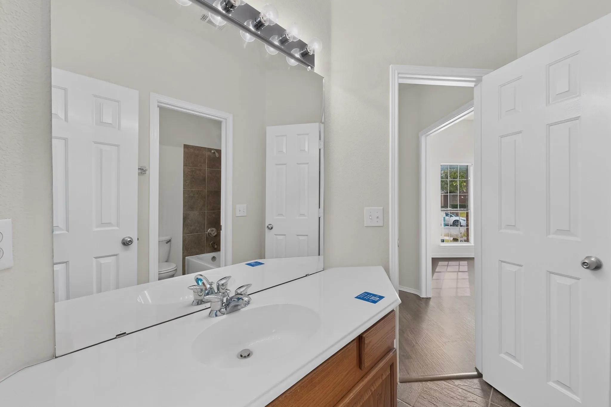 Vanity with an integrated sink and wood-finish cabinetry