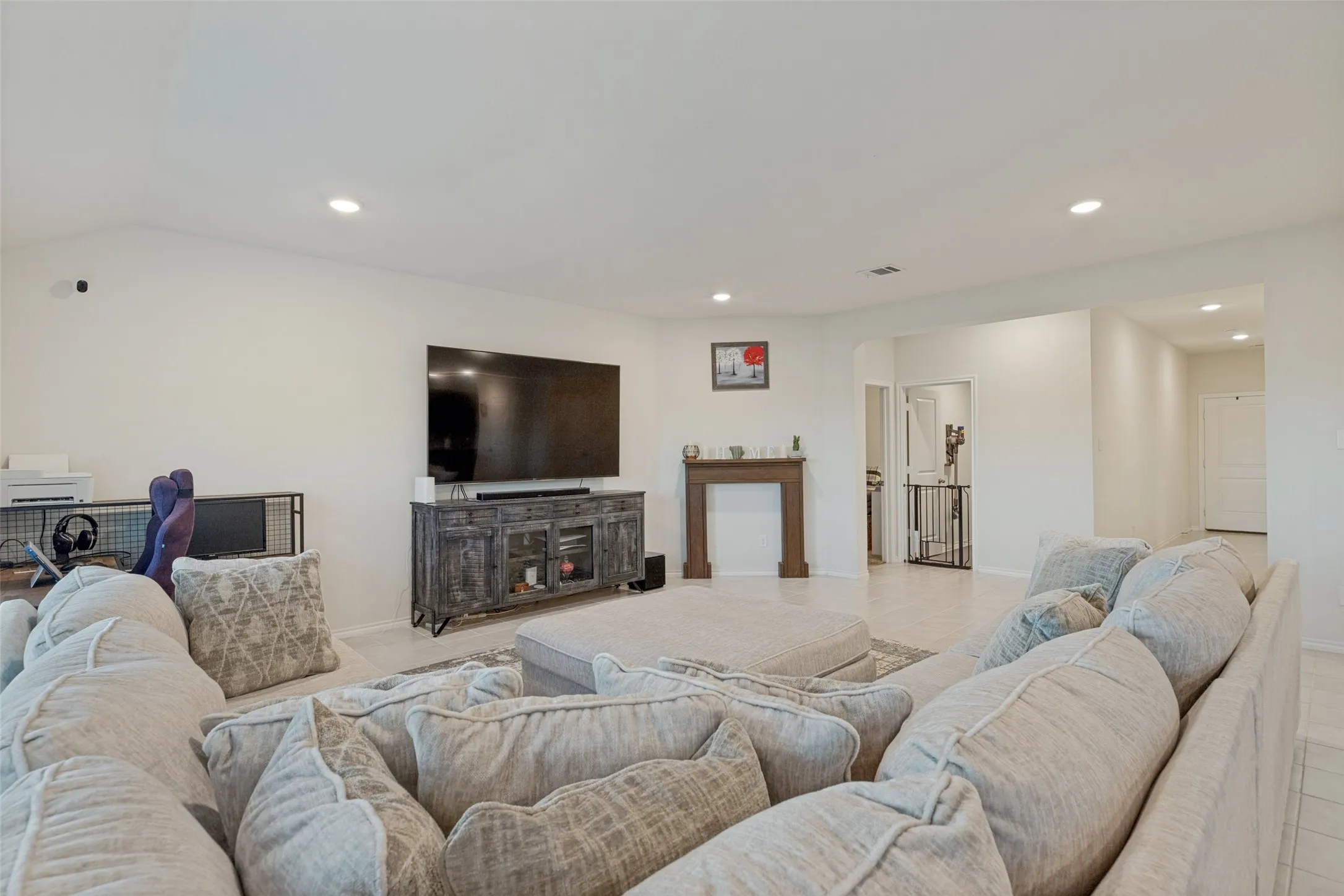 Recessed lighting, light-toned walls, and wood-finish flooring