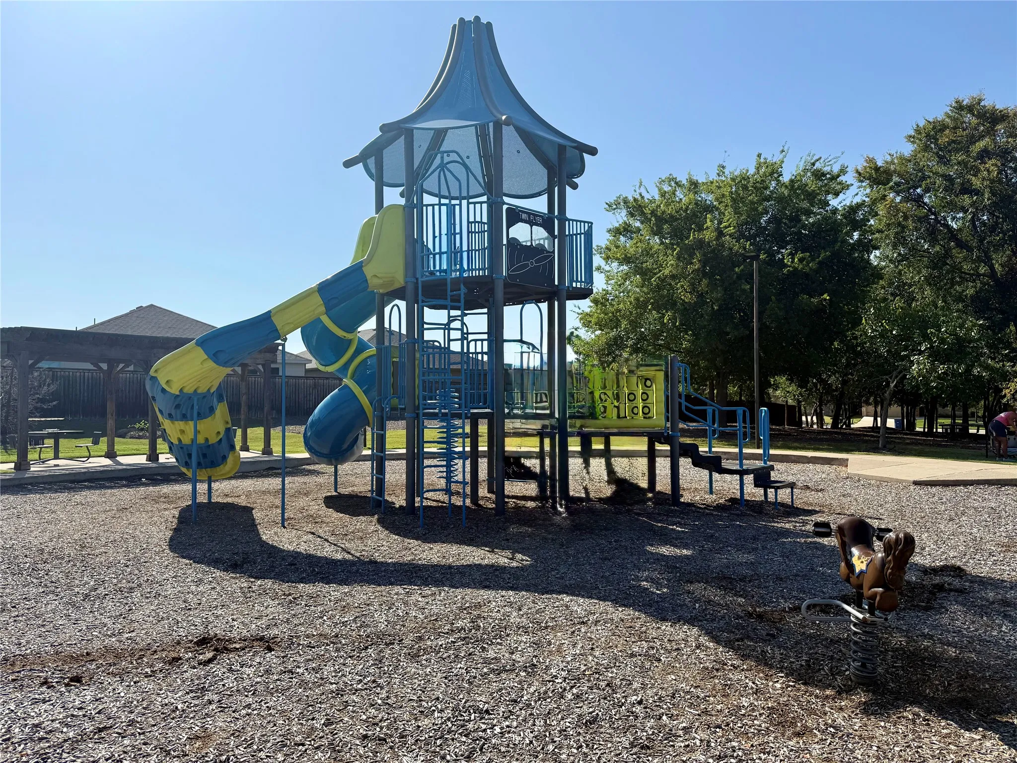 Playground structure featuring a spiral slide, climbing ladders, and multiple platforms
