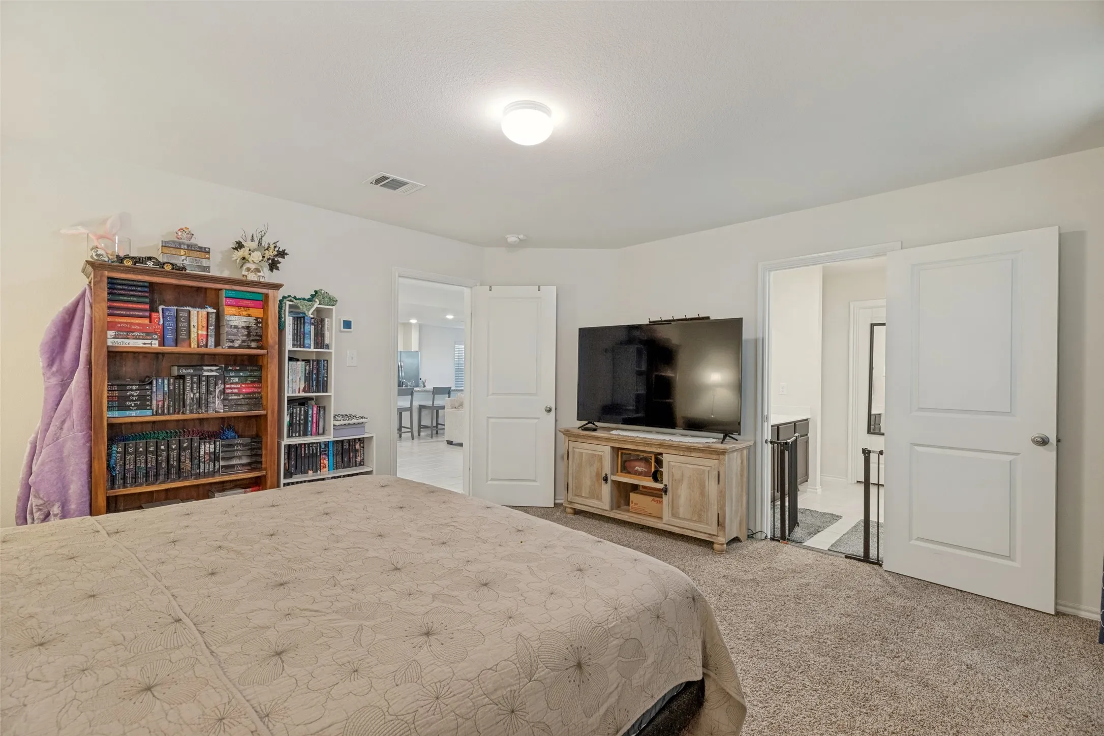 Carpeted flooring, white interior doors, and overhead dome lighting