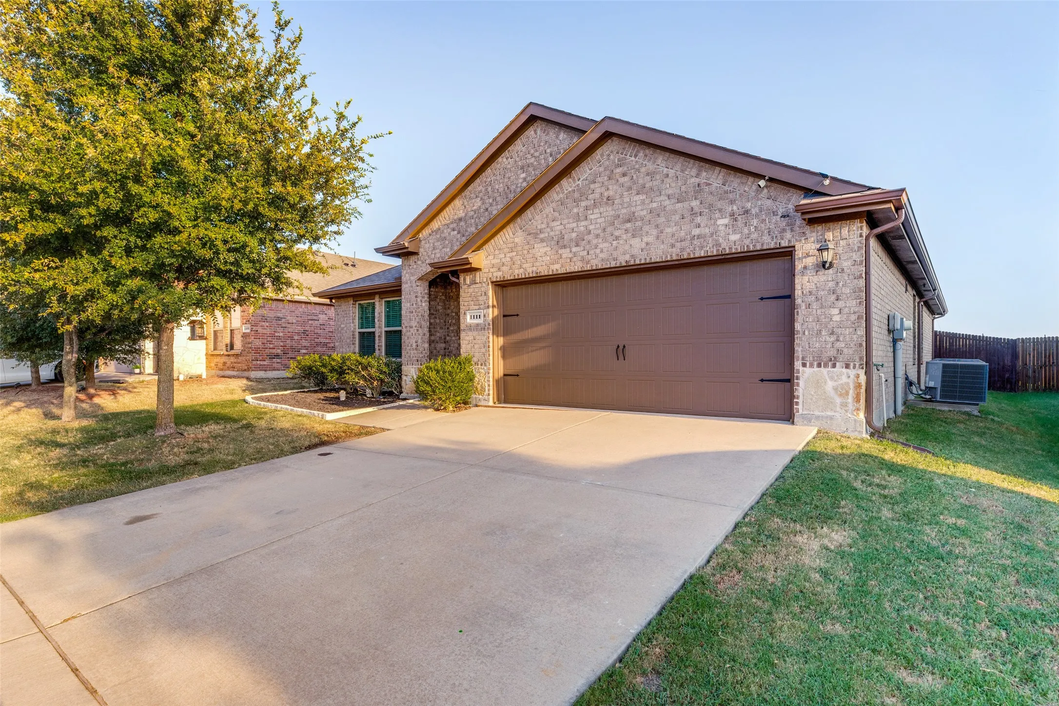 Brick exterior with stone accents and a two-car garage