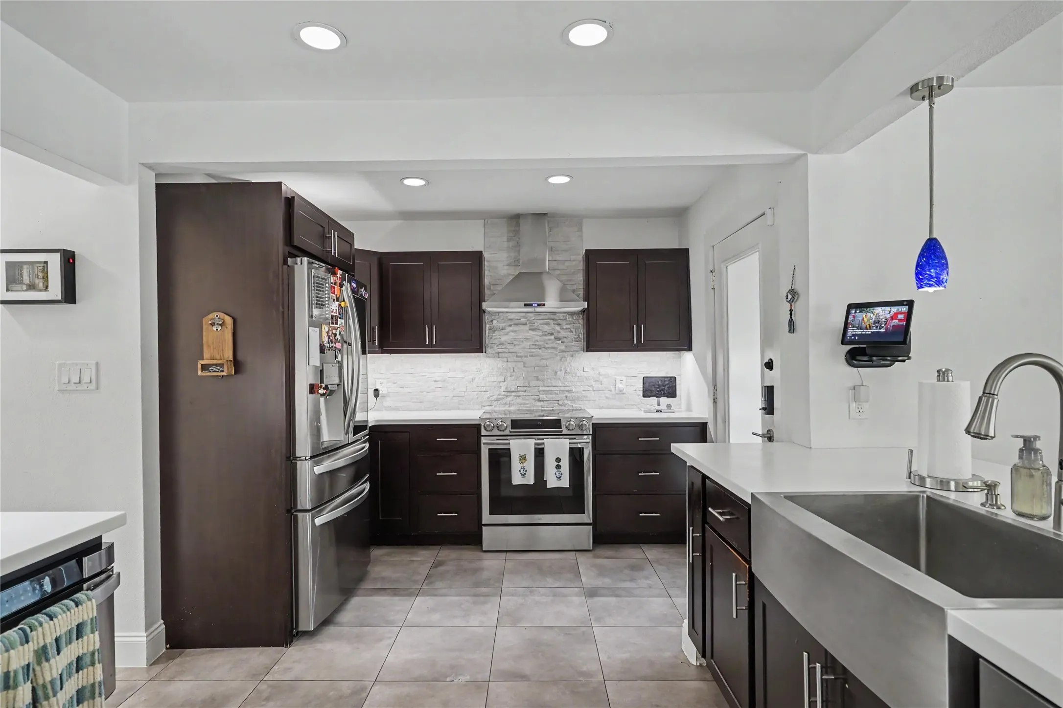 Updated kitchen with quartz counters, decorative backsplash