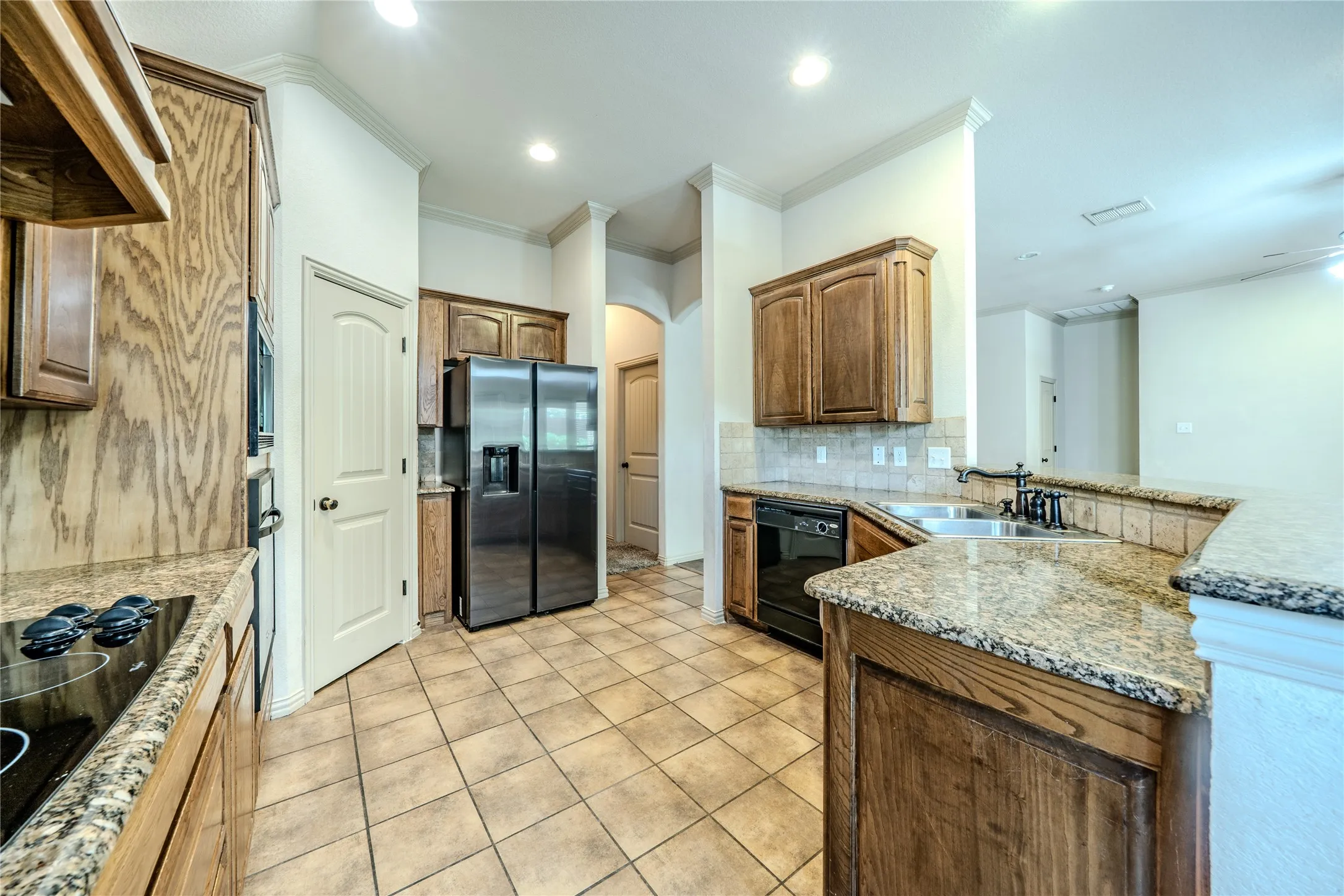 Electric cooktop and refrigerator with lots of work space.