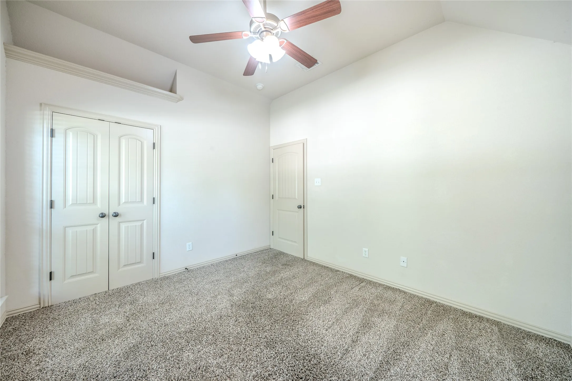 View of front bedroom and flat closet