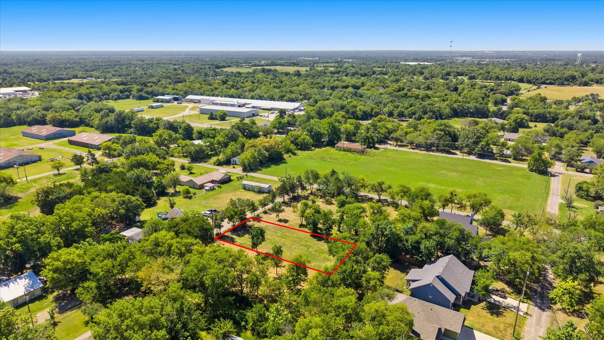 Expansive lot featuring mature trees and open green space