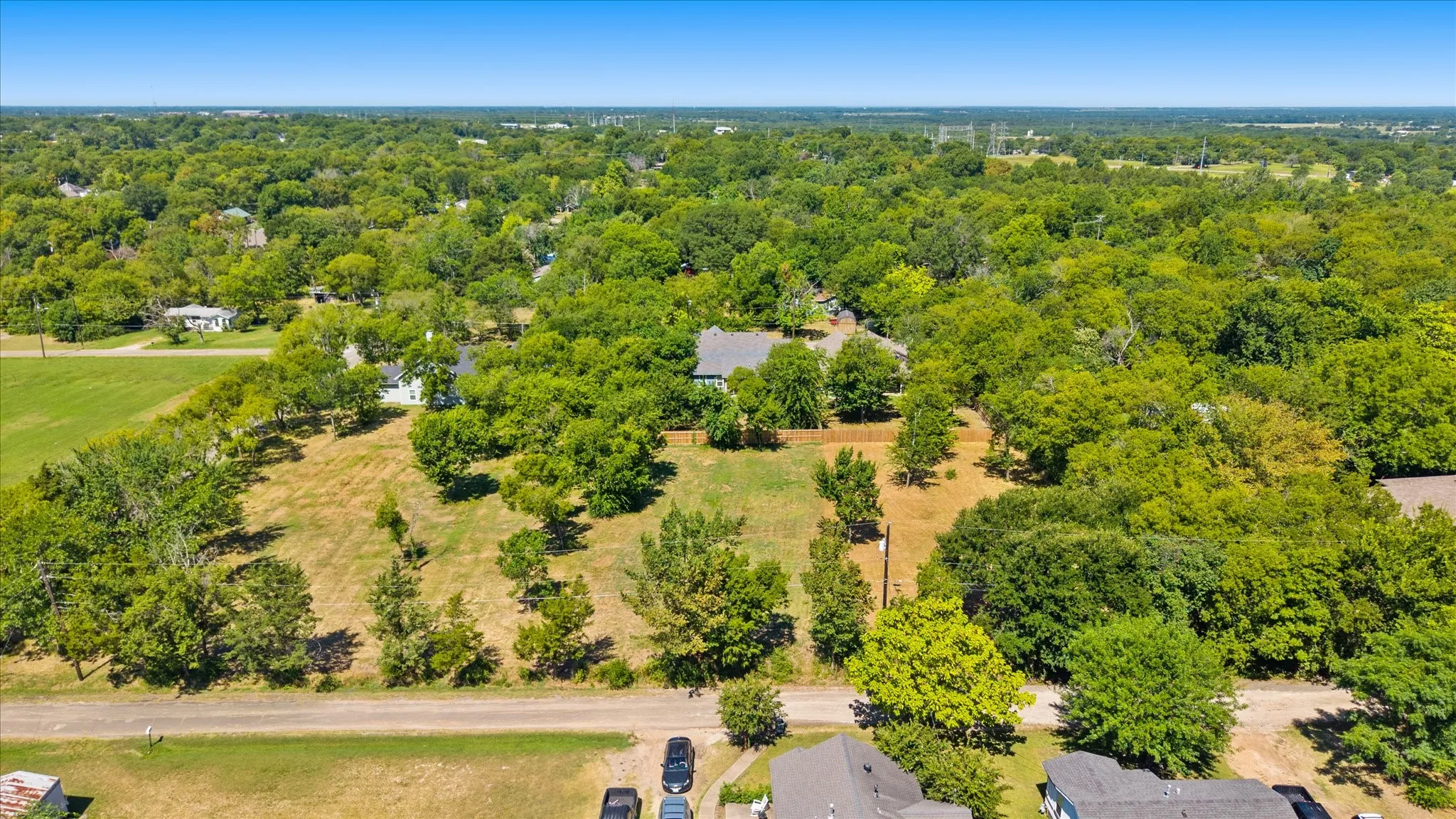 Expansive lot with varied topography, mature trees, and natural landscaping