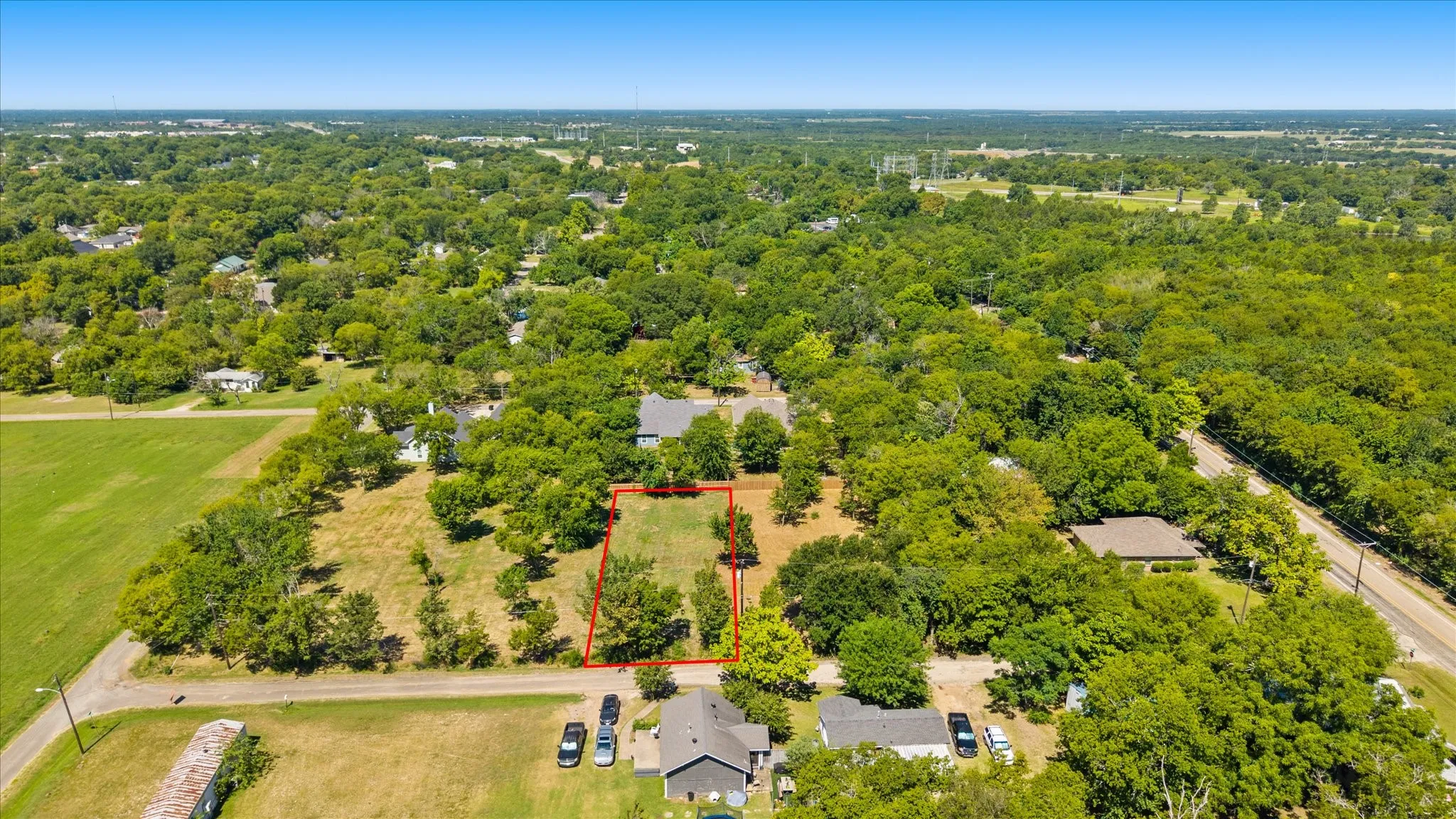 Cleared lot with mature trees and direct street frontage