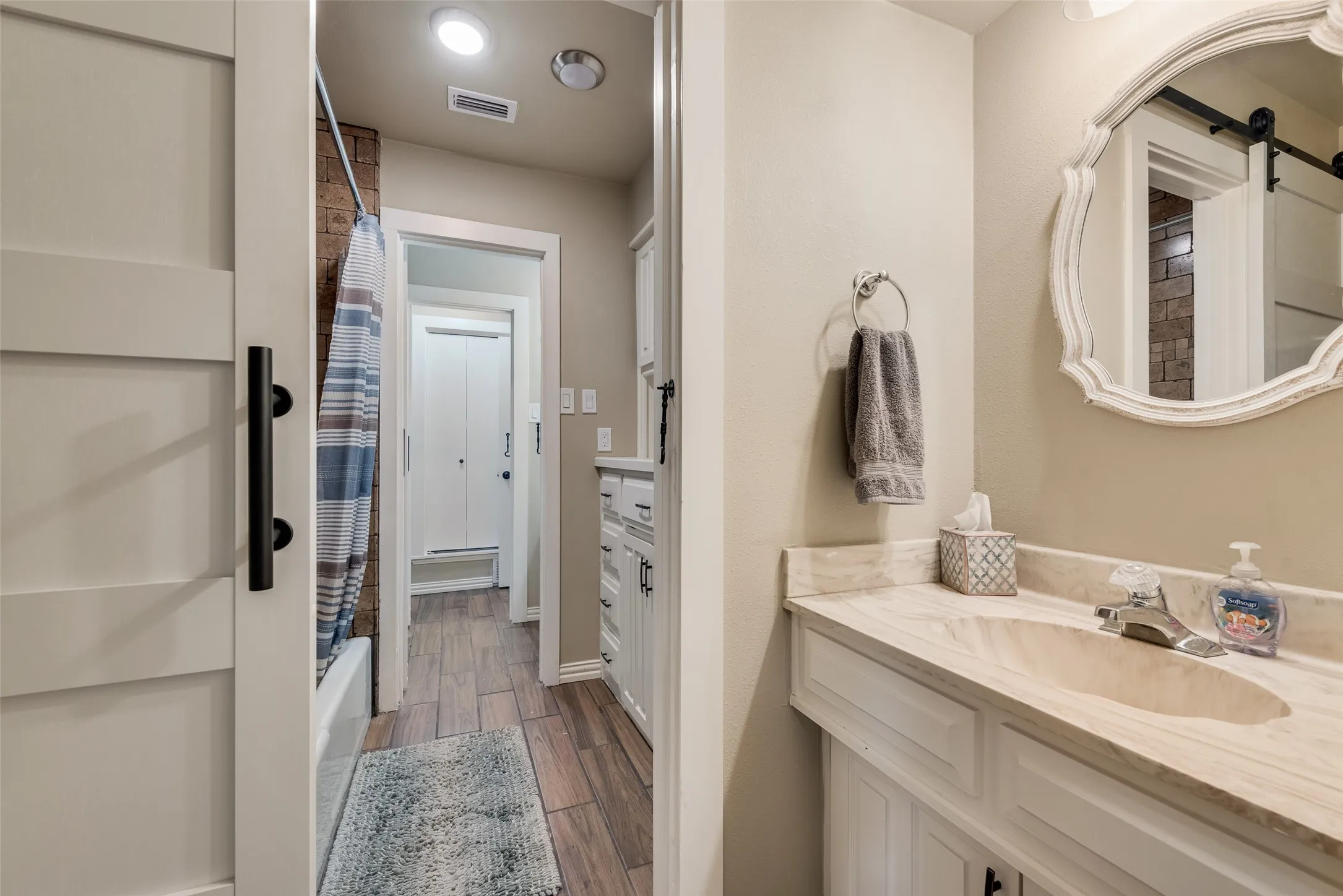 Vanity with an integrated sink and light-toned countertop